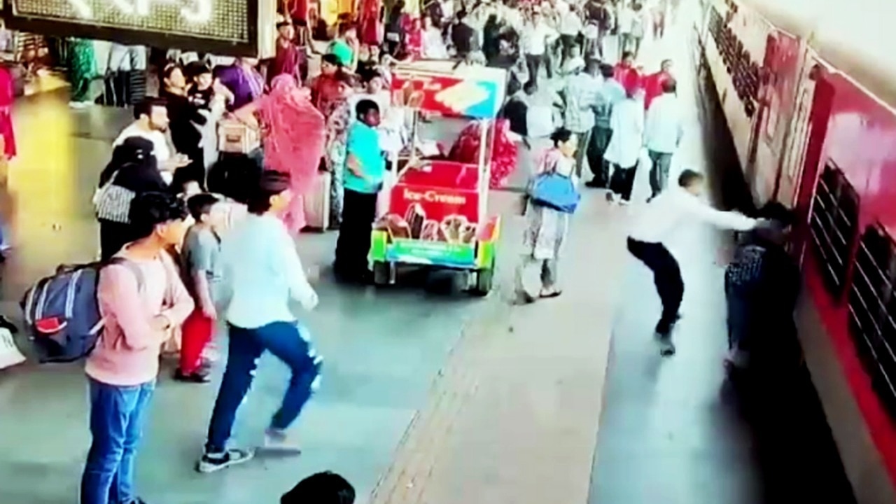 Video: Cops save woman from falling under moving train at Surat railway station