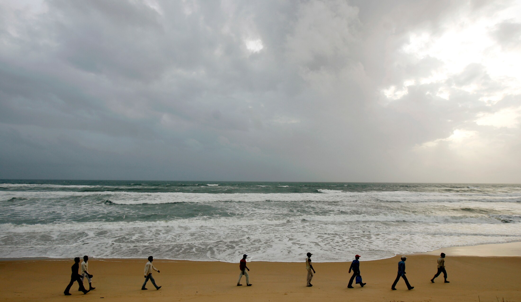 People walk on Benaulim beach in Goa. (Photo: Reuters)