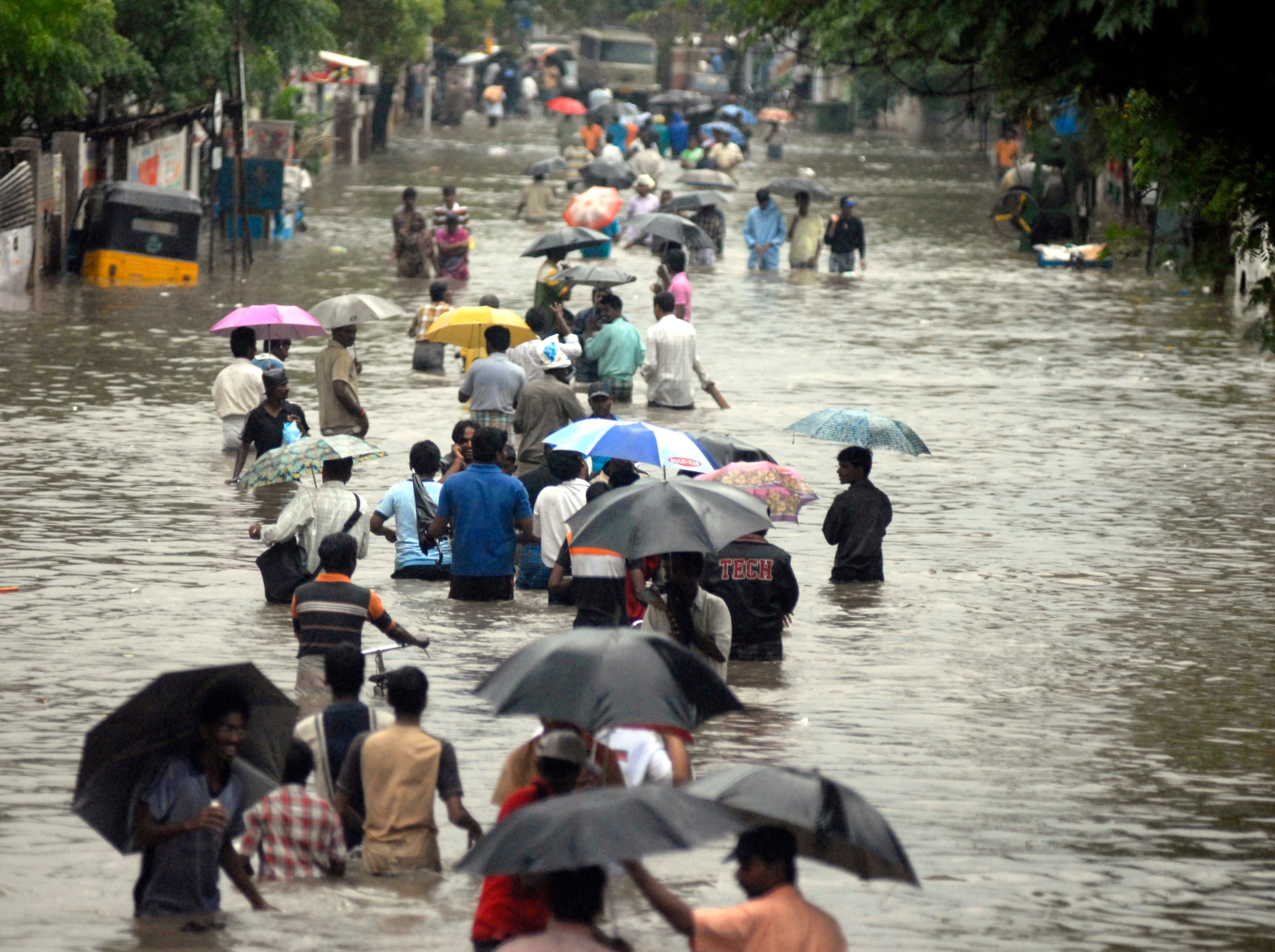 People wade through a flooded road after heavy rains in Chennai, Tamil Nadu. (Photo: Reuters)