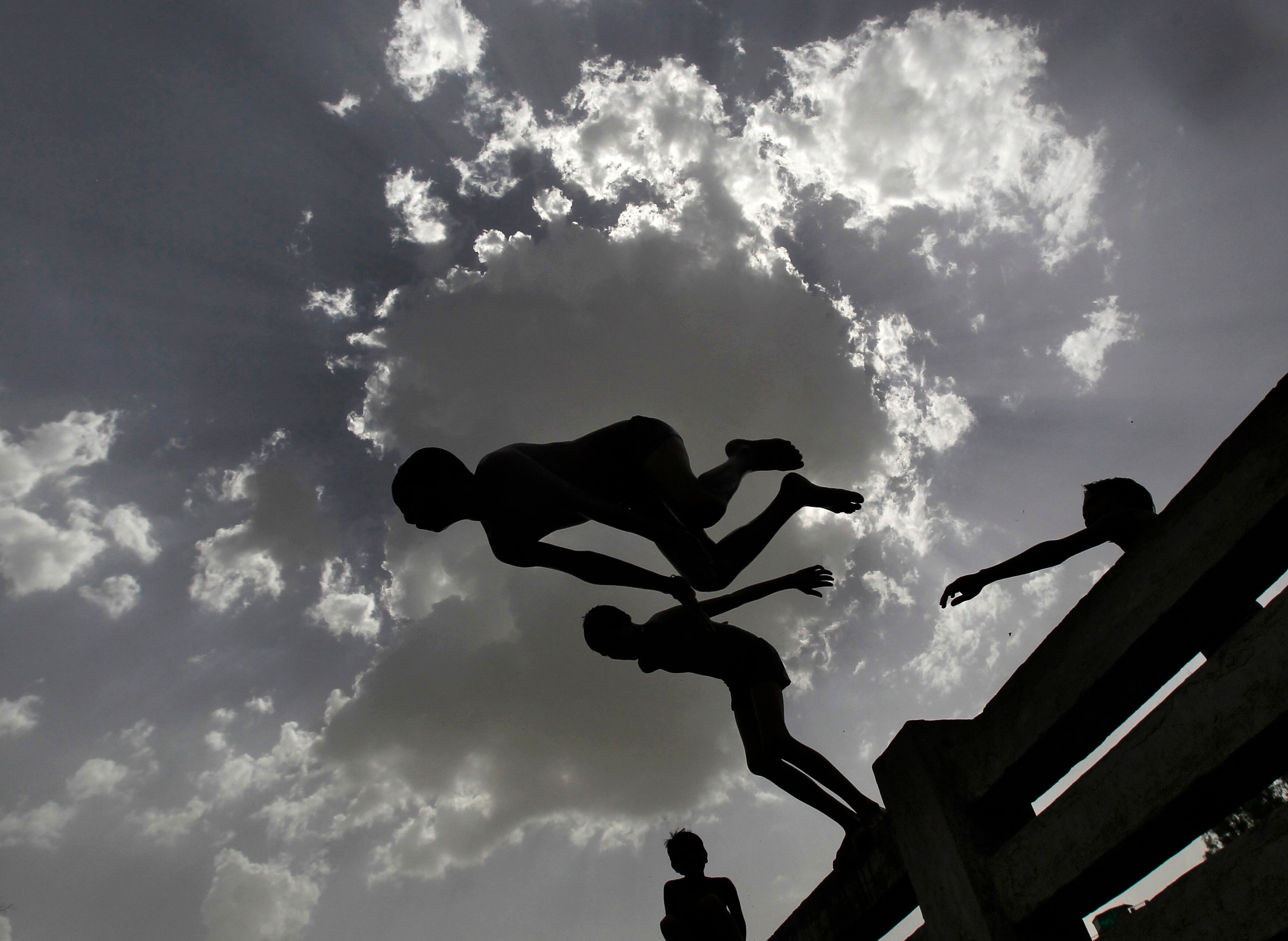 Boys jump into a canal during a hot day in New Delhi. (Photo: Reuters)
