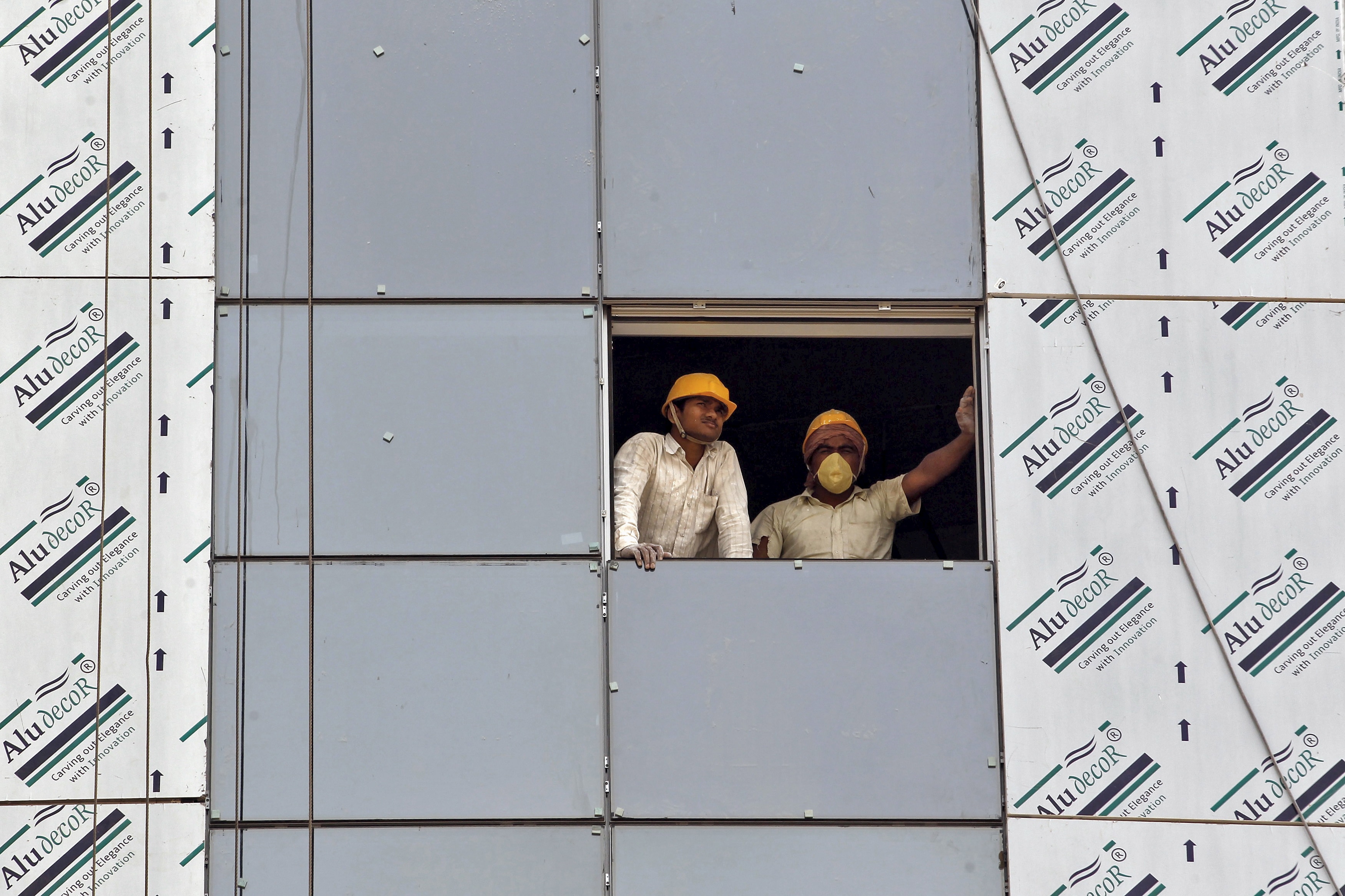 Labourers look out from a window of a data centre building under construction in Gujarat. (Photo: Reuters)