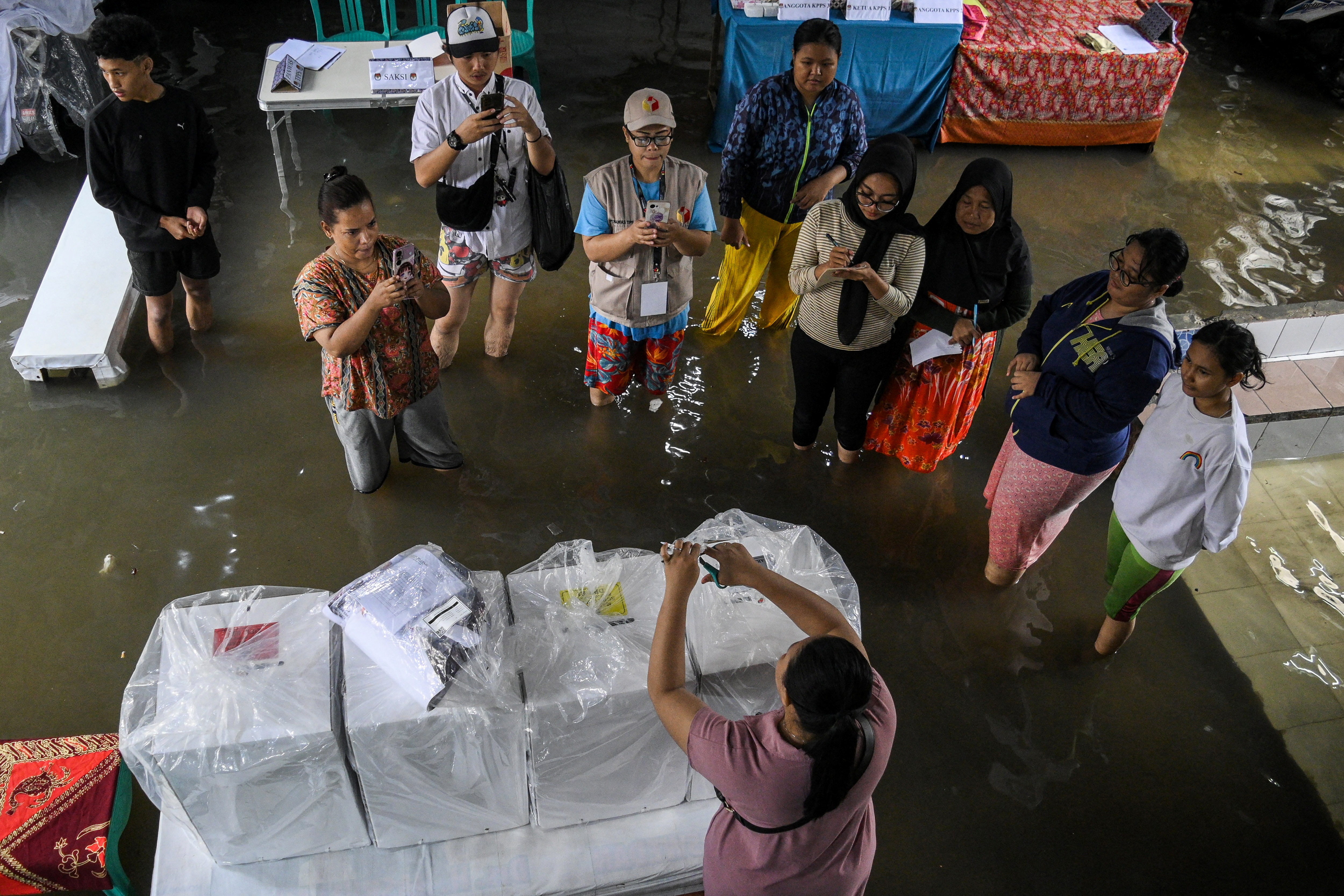 Electoral officers prepare ballot boxes at a flooded general election polling station in Indonesia. (Photo: Reuters)
