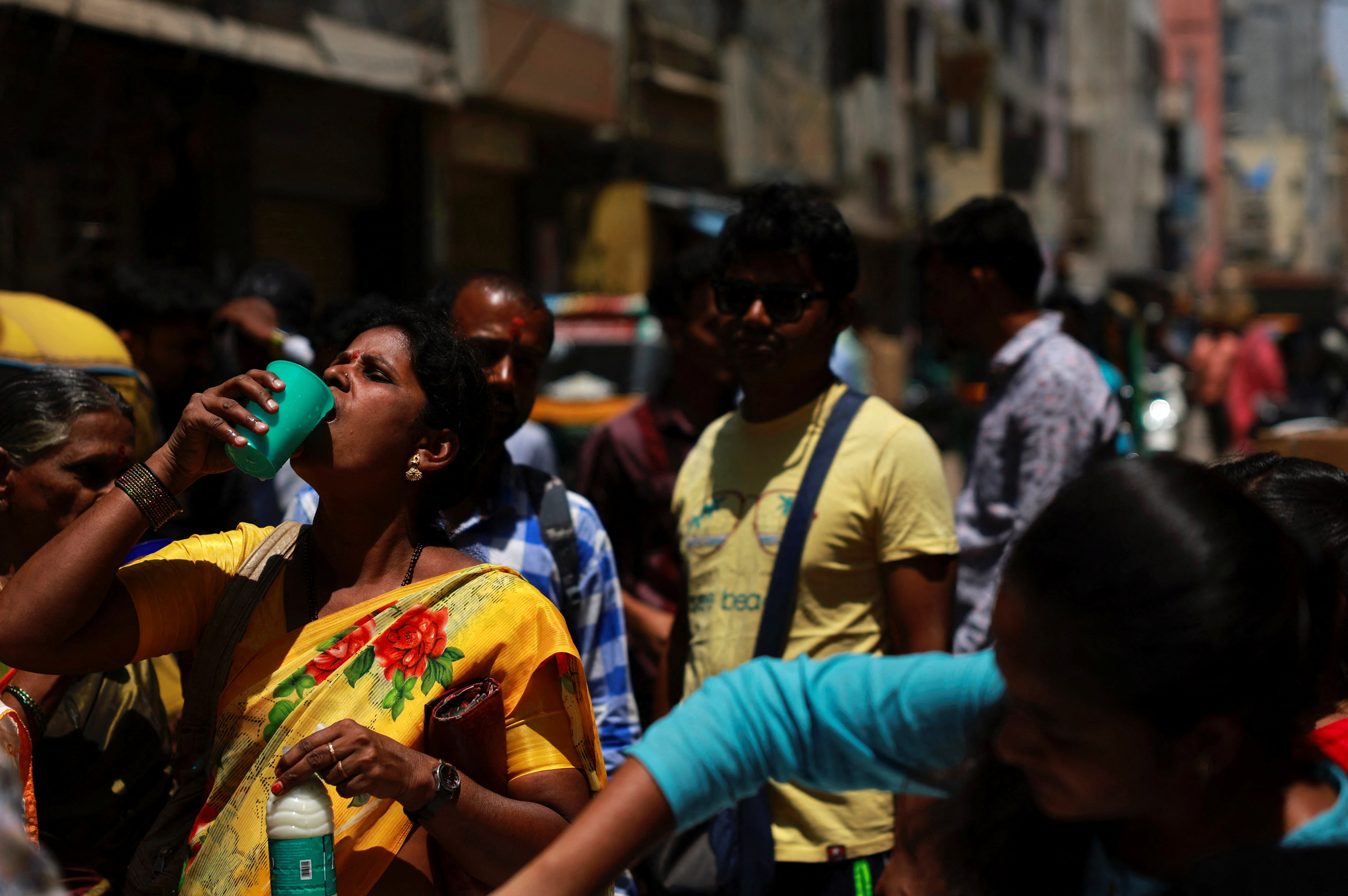 A woman drinks curd to cool herself down during a hot day in Bengaluru. (Photo: Reuters)