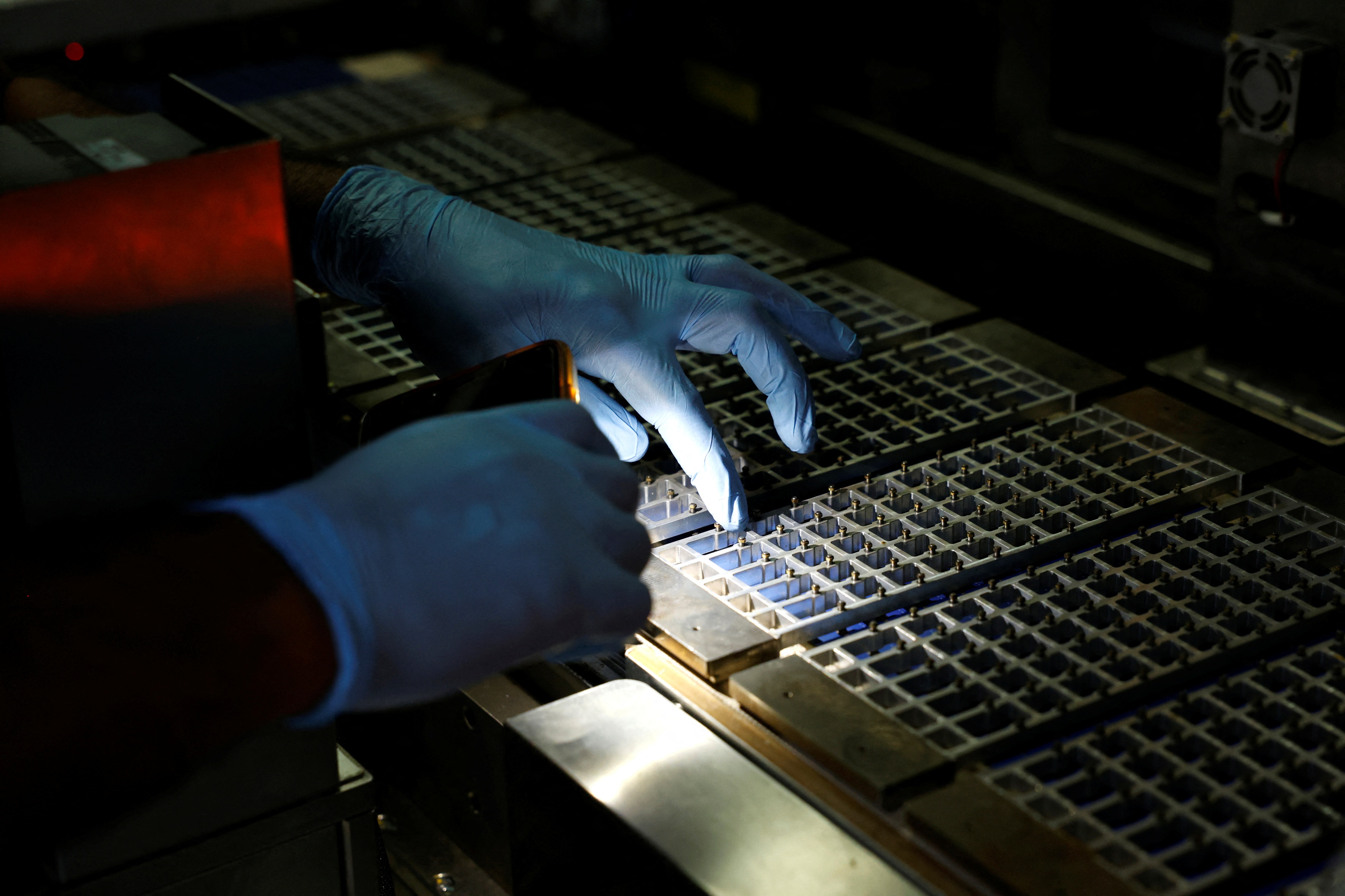 A technician checks the machine at a solar panel manufacturing hub in Greater Noida. (Photo: Reuters)