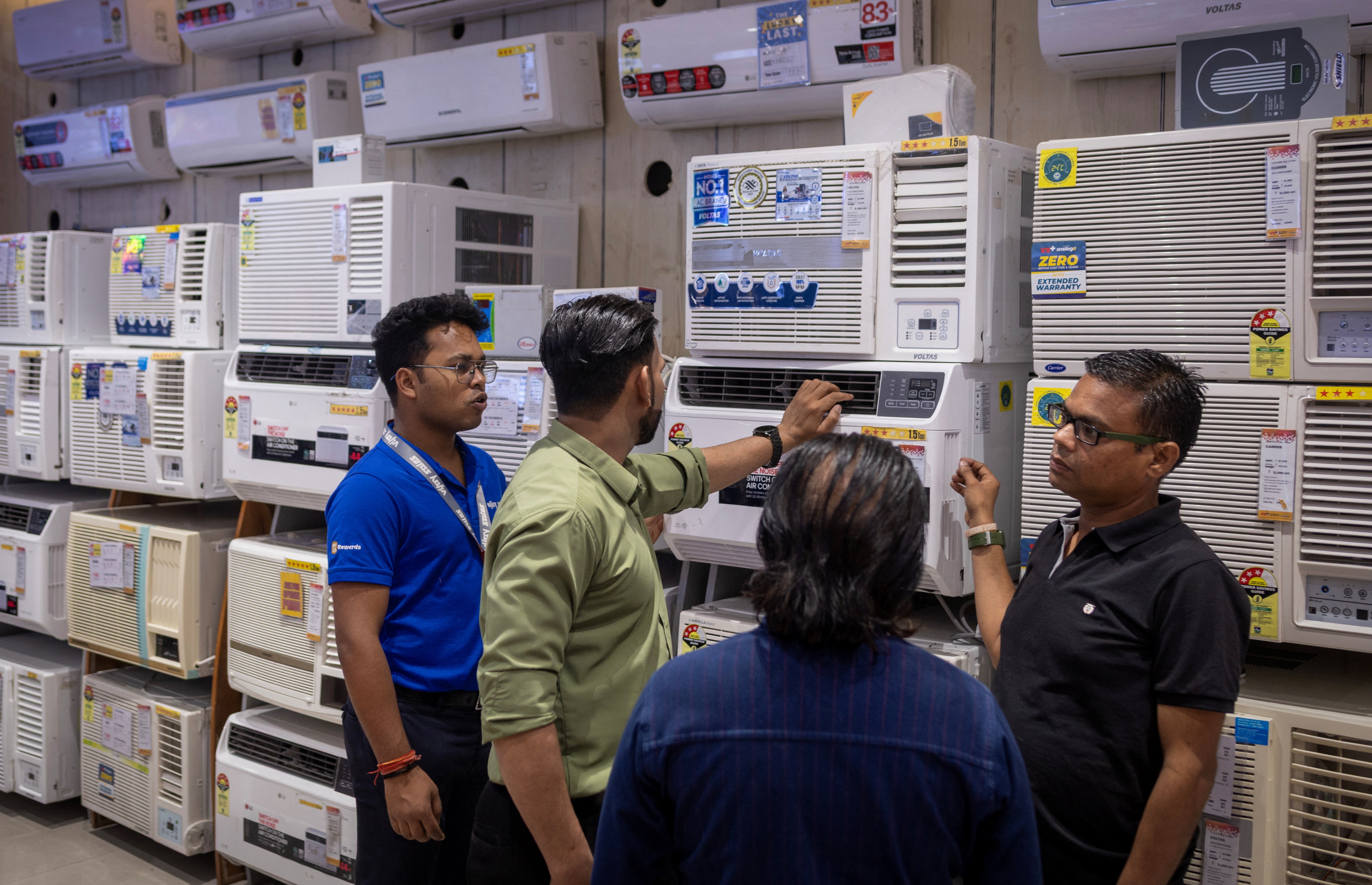 Customers look at ACs displayed inside an electronics store, on a hot day in New Delhi. (Photo: Reuters)