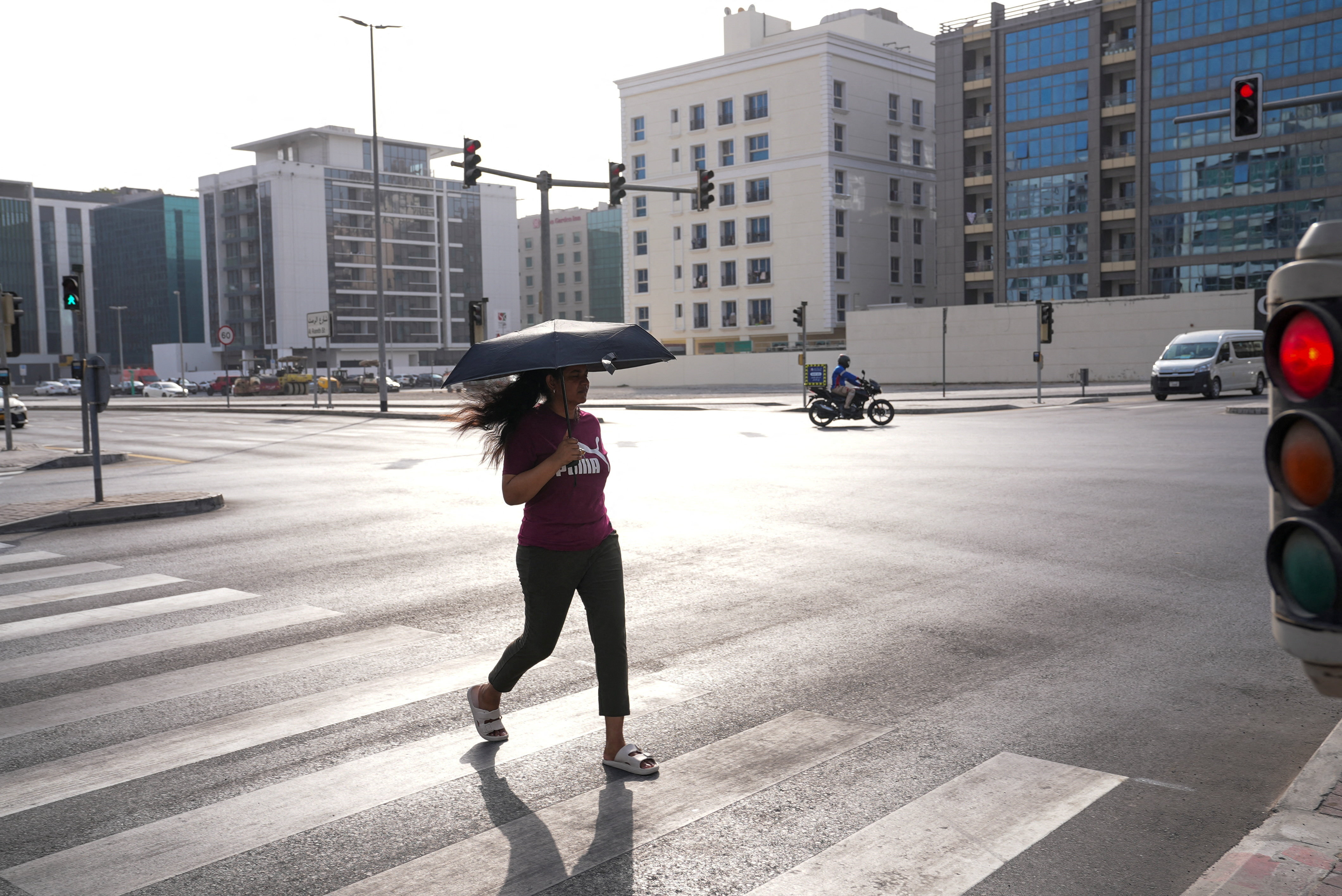 A pedestrian crosses the street during a 2025 heatwave in Dubai. (Photo: Reuters)