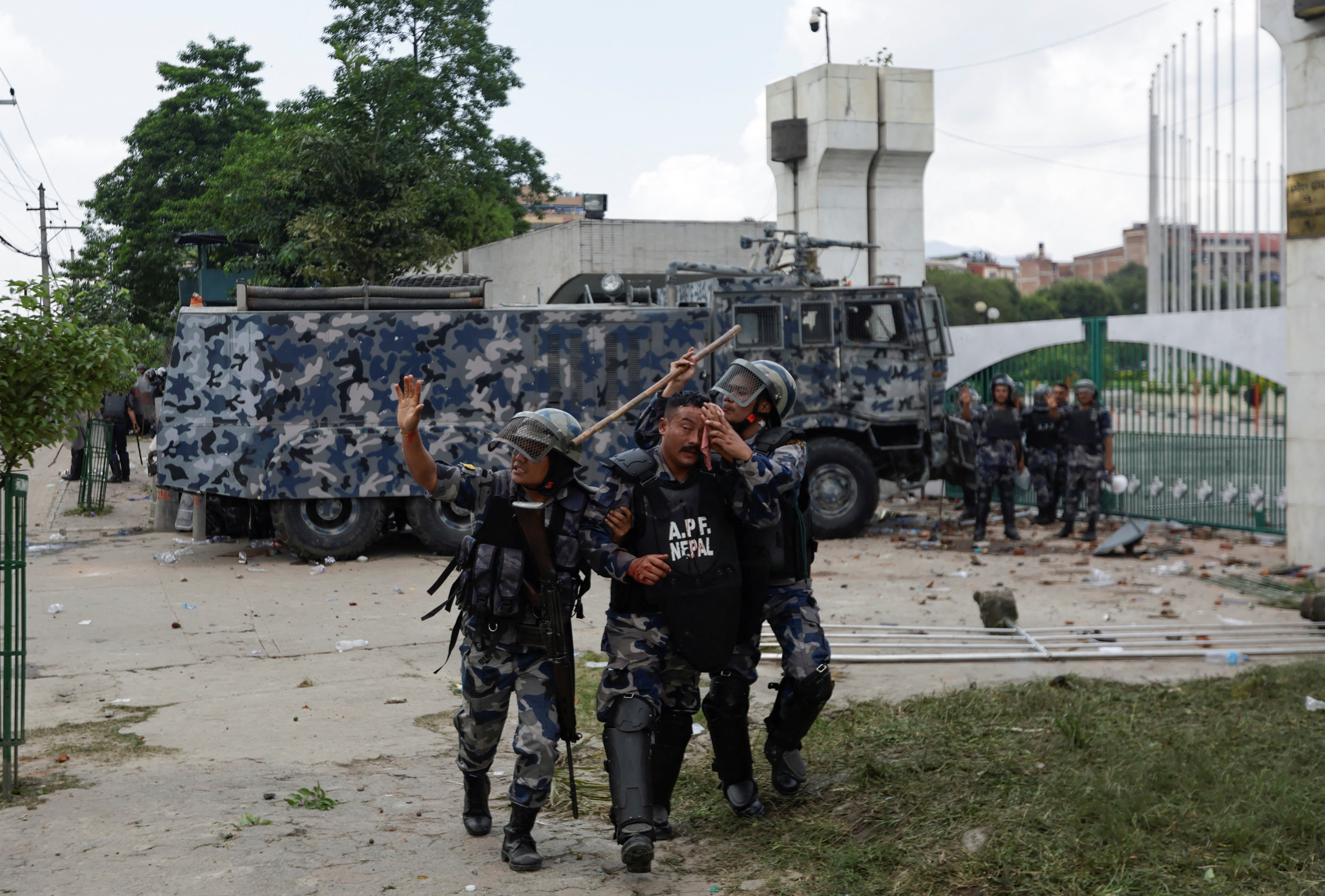 A riot police officer is taken to the hospital after being injured during a protest against corruption and the government’s decision to block several social media platforms, outside the parliament in Kathmandu, Nepal, September 8, 2025. 