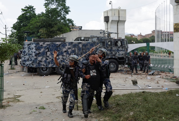 A riot police officer is taken to the hospital after being injured during a protest against corruption and the government’s decision to block several social media platforms, outside the parliament in Kathmandu, Nepal, September 8, 2025.