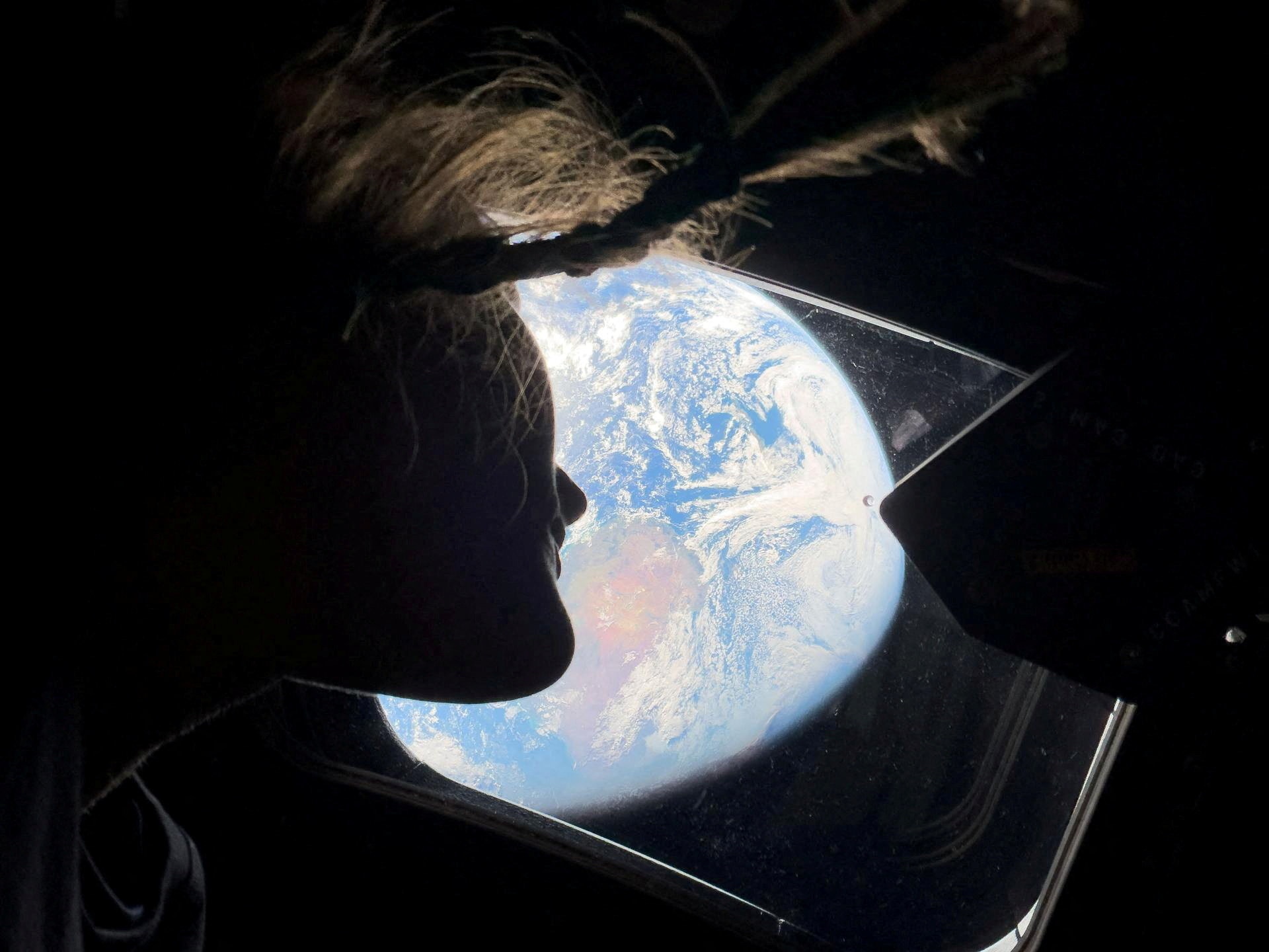 Christina Koch looks at Earth from space aboard the Artemis 2 spacecraft. (Photo: Nasa)