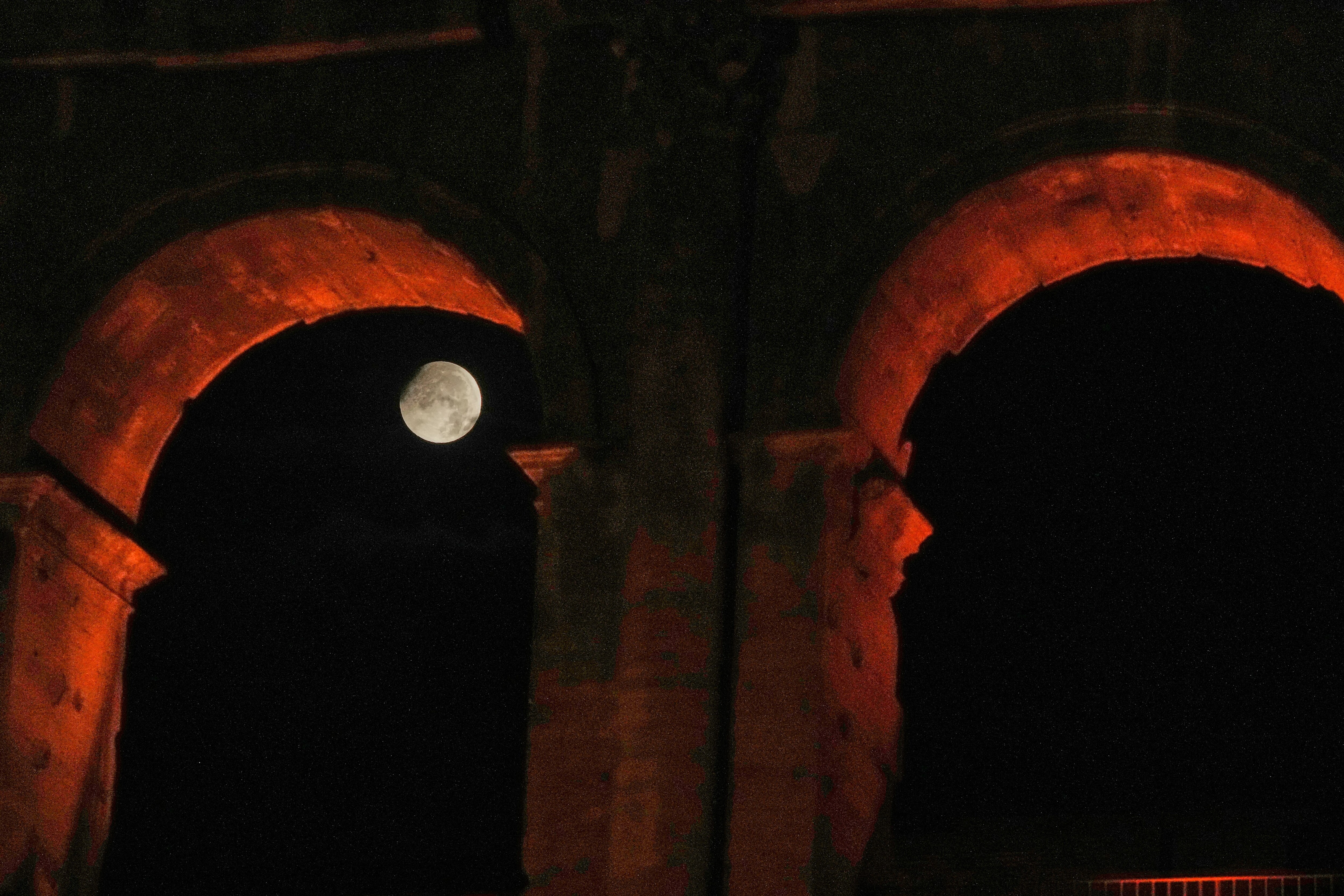 The Moon is seen setting behind the Colosseum in Rome, Italy. (Photo: AP)