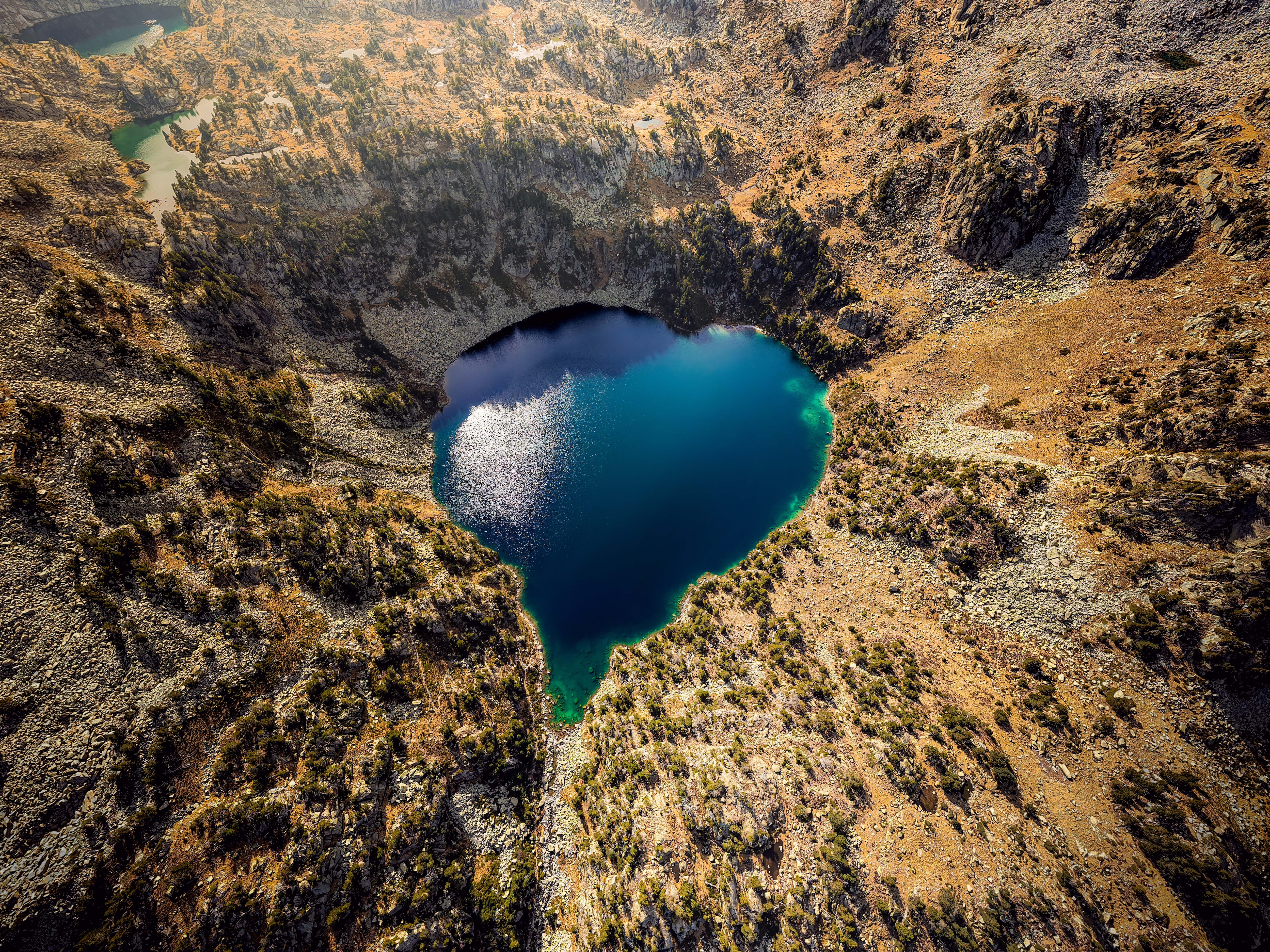 An aerial drone view of a heart shaped glacial lake. (Photo: Getty)