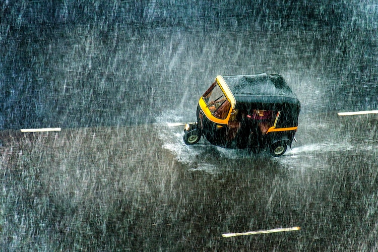 An auto-rickshaw plies throguh heavy monsoon rain. (Photo: Getty)