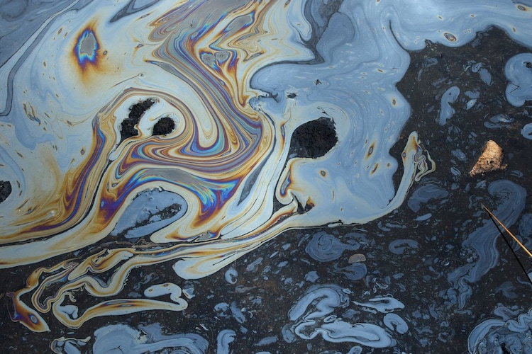 A photo showing a layer of oil on top of water surface after an oil spill. (Photo: X/@GovAcctProj)