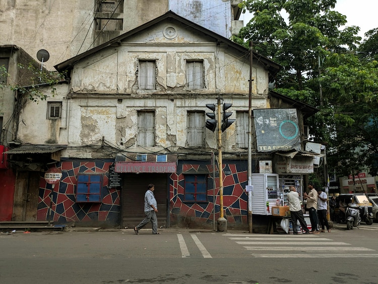 An image of an old building on a busy street in Pune. (Photo: PTI)