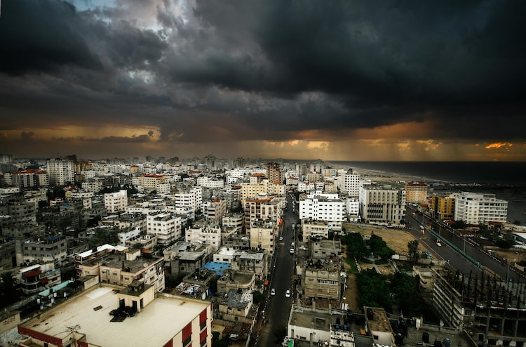 City view of Gaza under dark clouds with rain on the horizon illustarting weather and war. (Photo: Pexels)