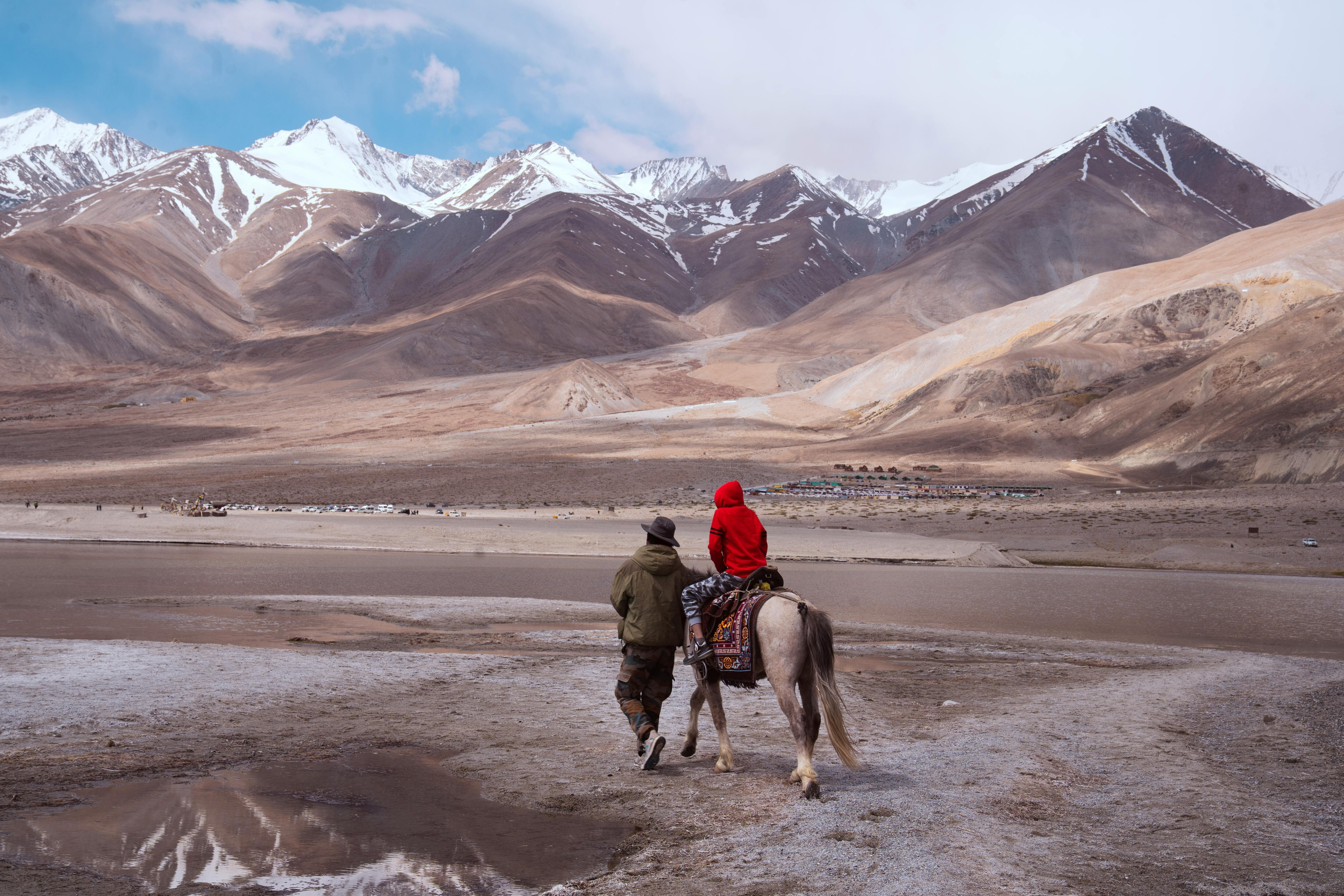 A person and child riding a horse in Ladakh. (Photo: Pexels)