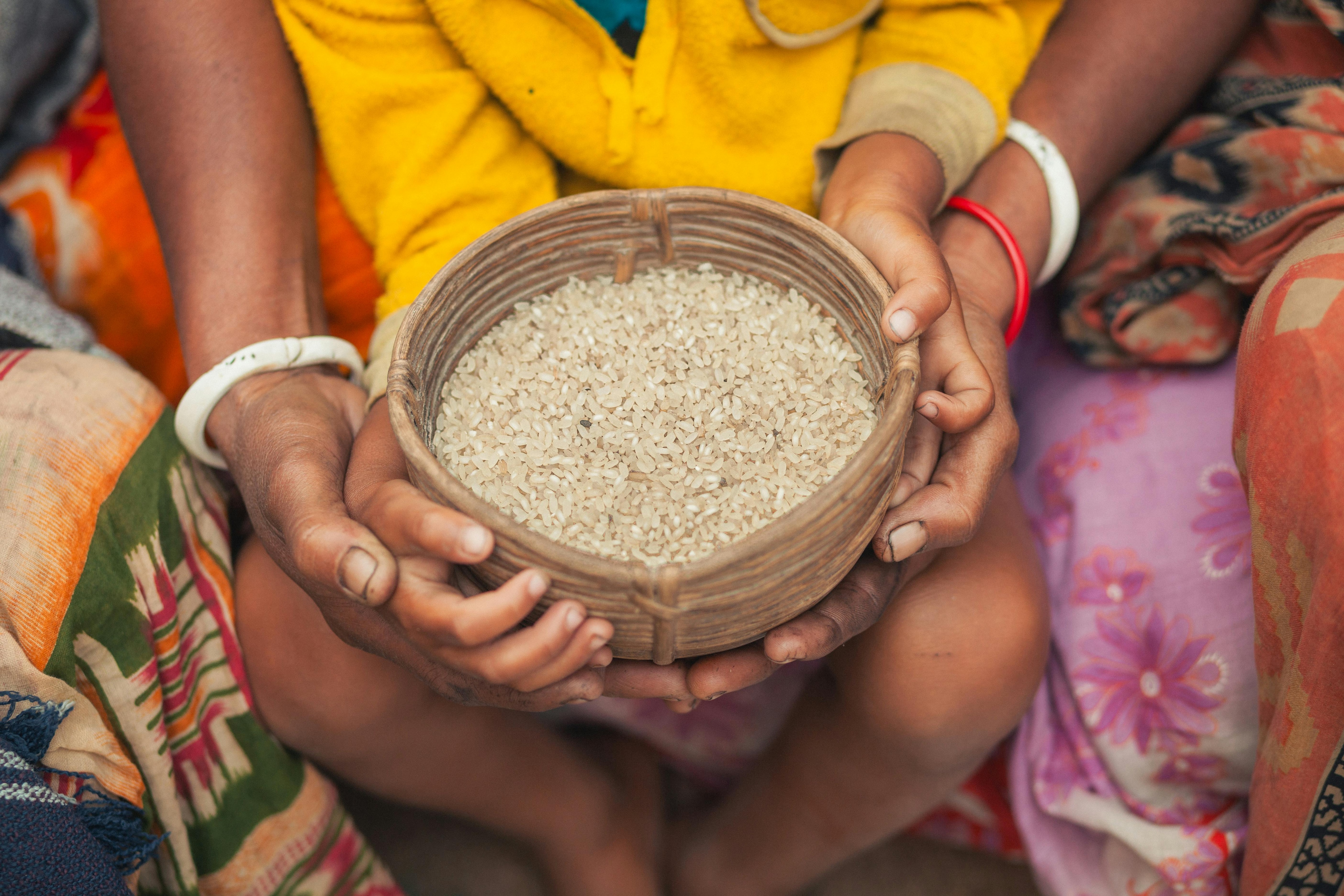 Close-up of hands holding a woven basket filled with rice in Bangladesh. (Photo: Pexels)