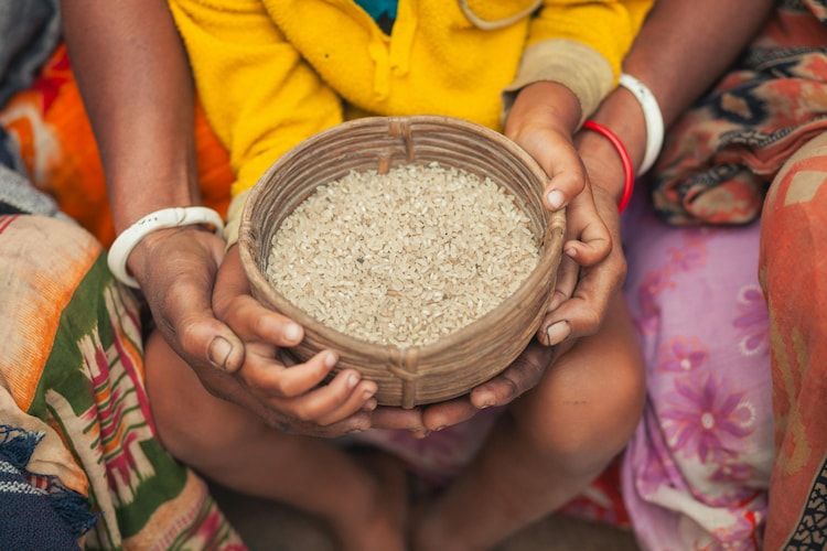 Close-up of hands holding a woven basket filled with rice in Bangladesh. (Photo: Pexels)