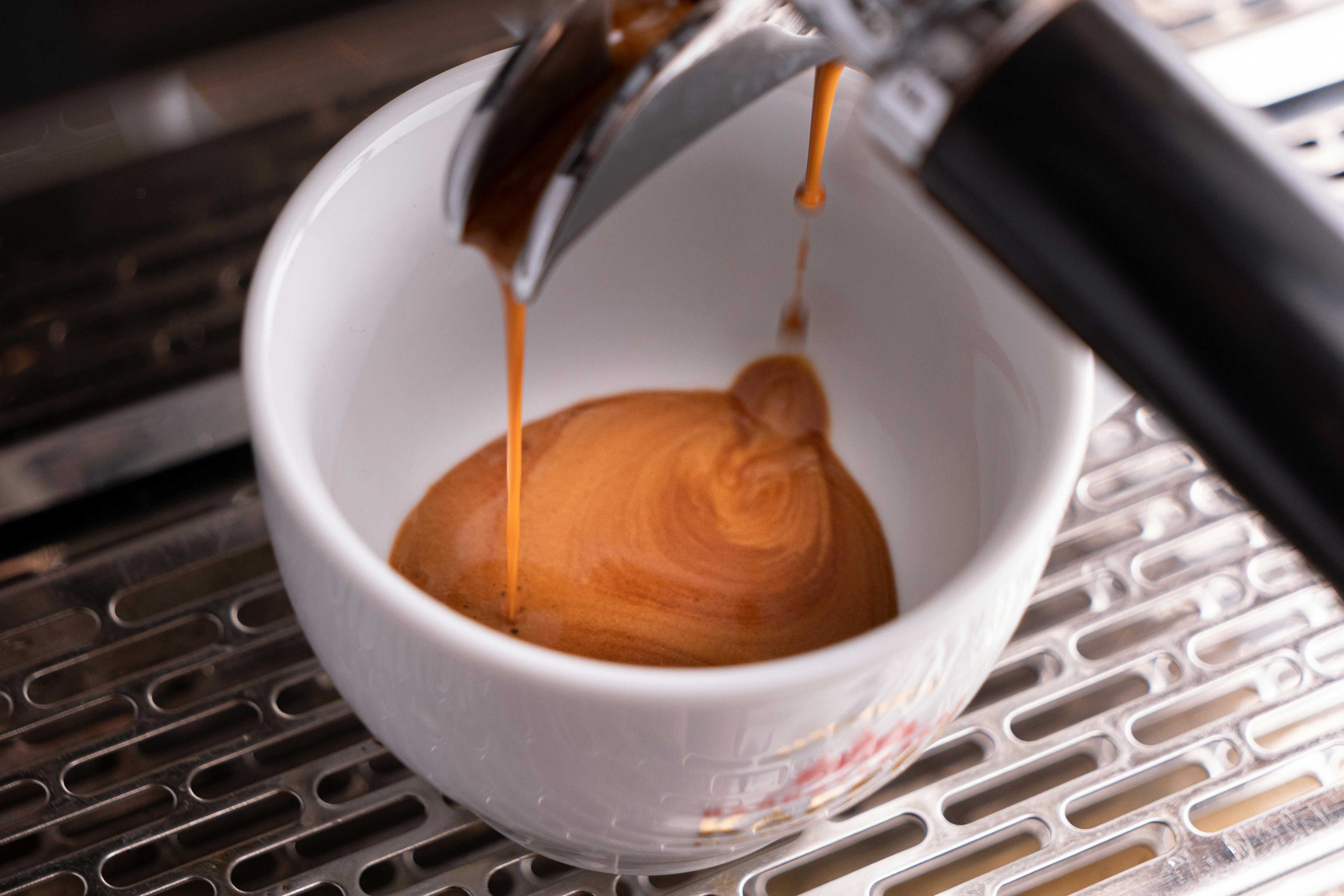 A view of espresso coffee being poured into a white cup. (Photo: Pexels)