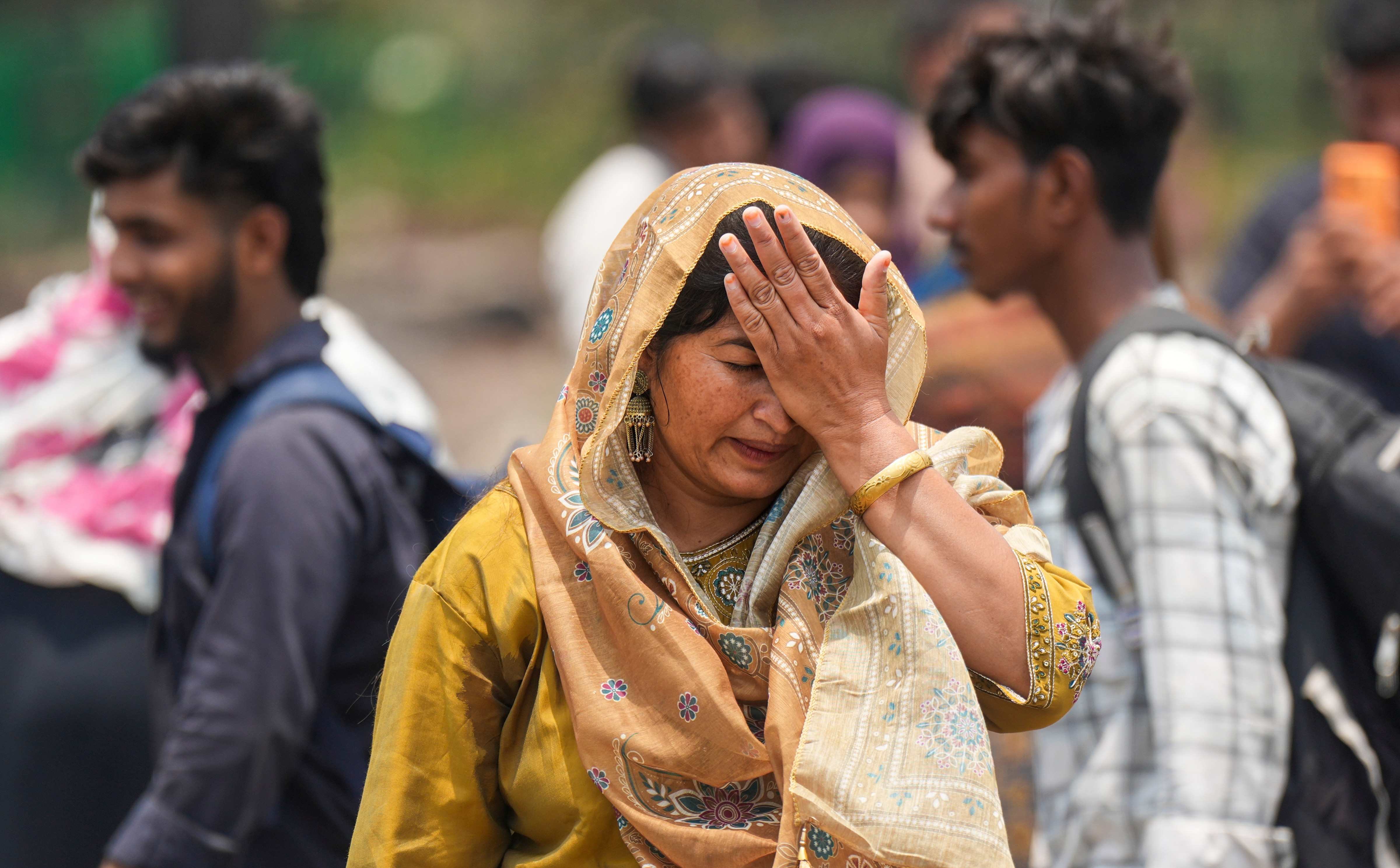 A woman in New Delhi wipes sweat off her face. (Photo: PTI)