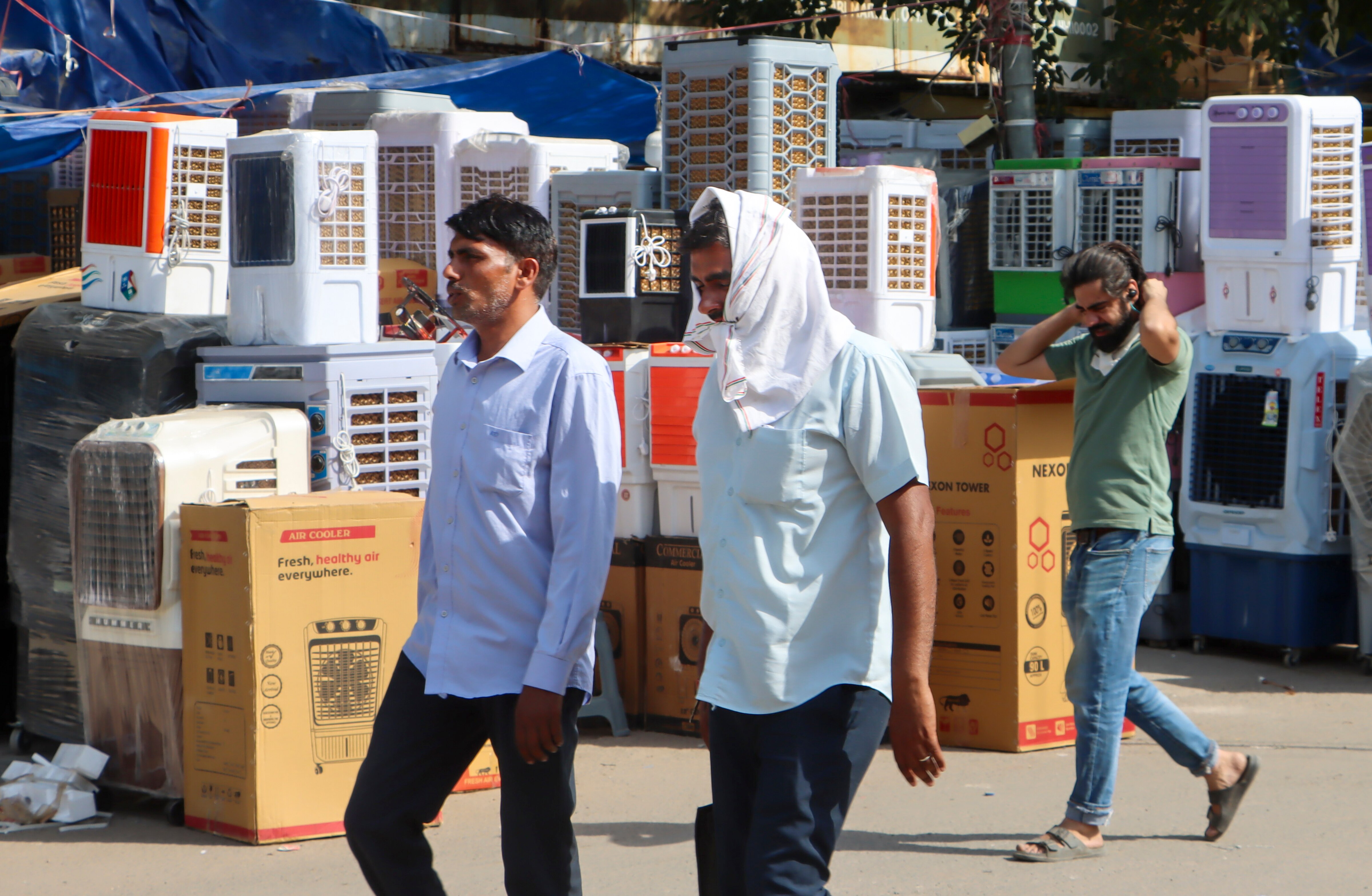 People walk past coolers and ACs put on display in New Delhi. (Photo: PTI)