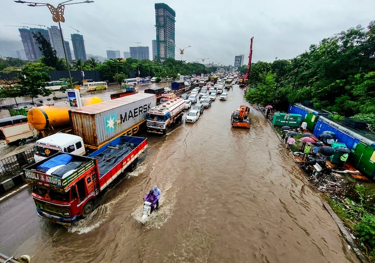Vehicles wade through waterlogged streets. (Photo: PTI)