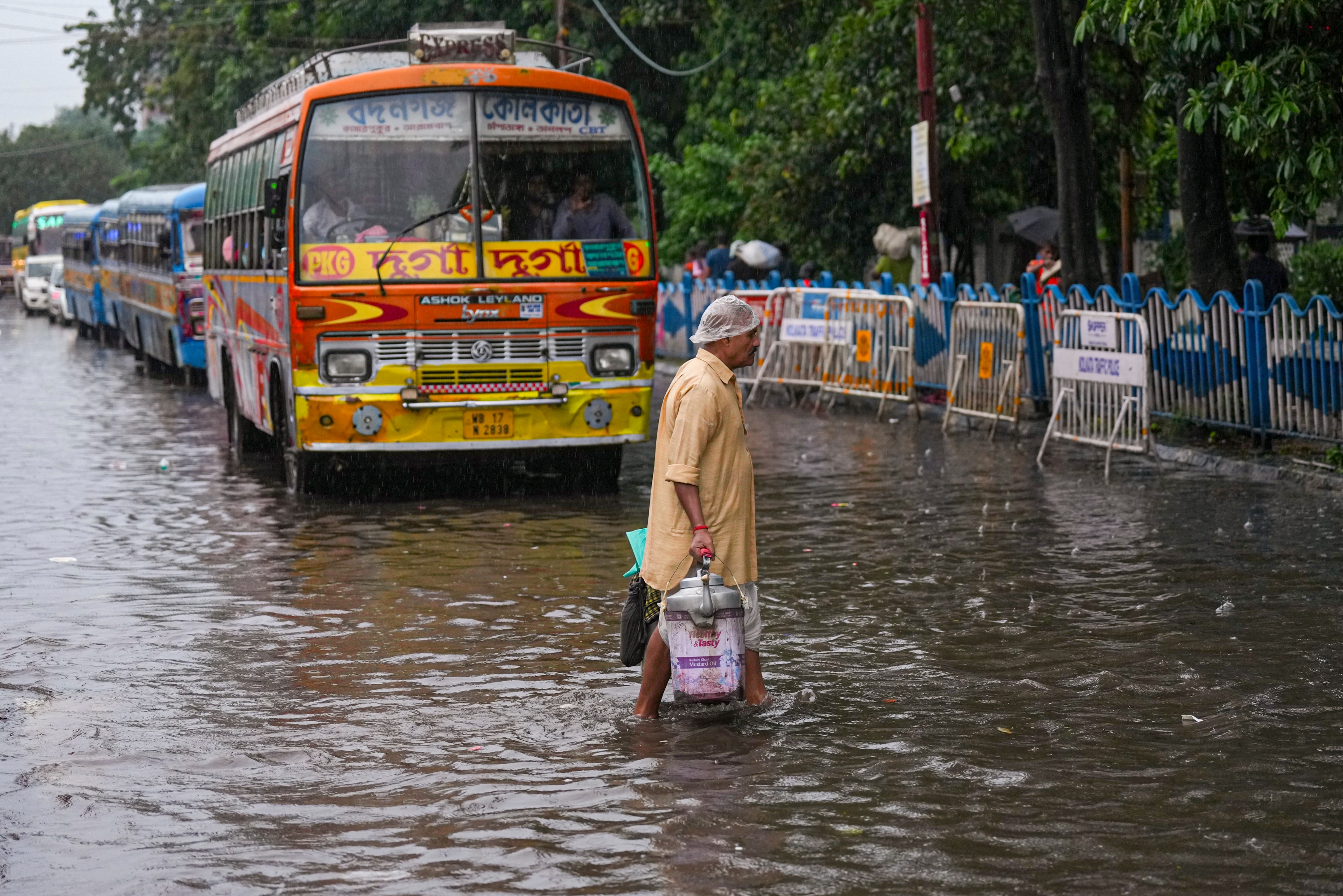 A person walks amid rainfall, in Kolkata, West Bengal. (Photo: PTI)