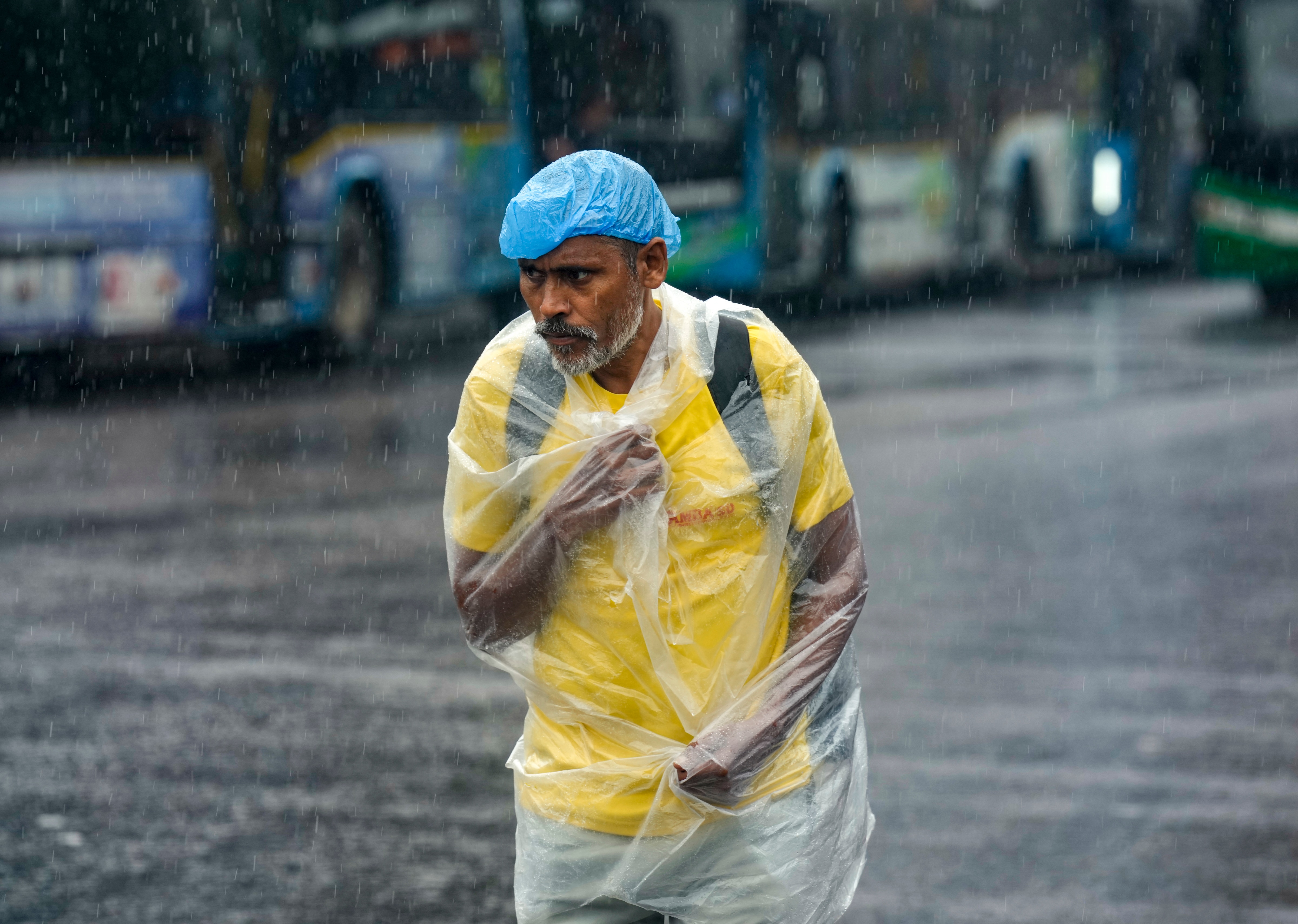 A man walks along a road amid monsoon rain in New Delhi. (Photo: PTI)