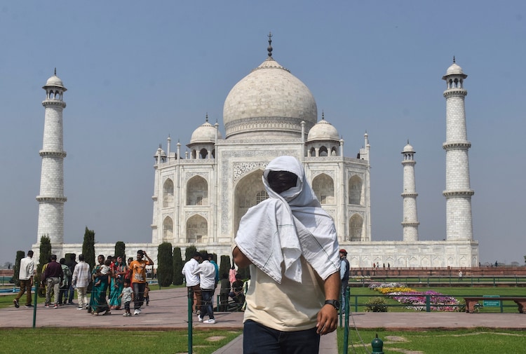 A man covers himself from the heat at the Taj Mahal. (Photo: PTI)