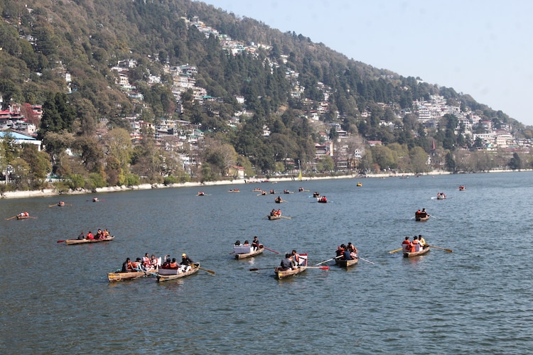 Tourists take boat ride at the Naini Lake in Nainital on a warm day. (Photo: PTI)
