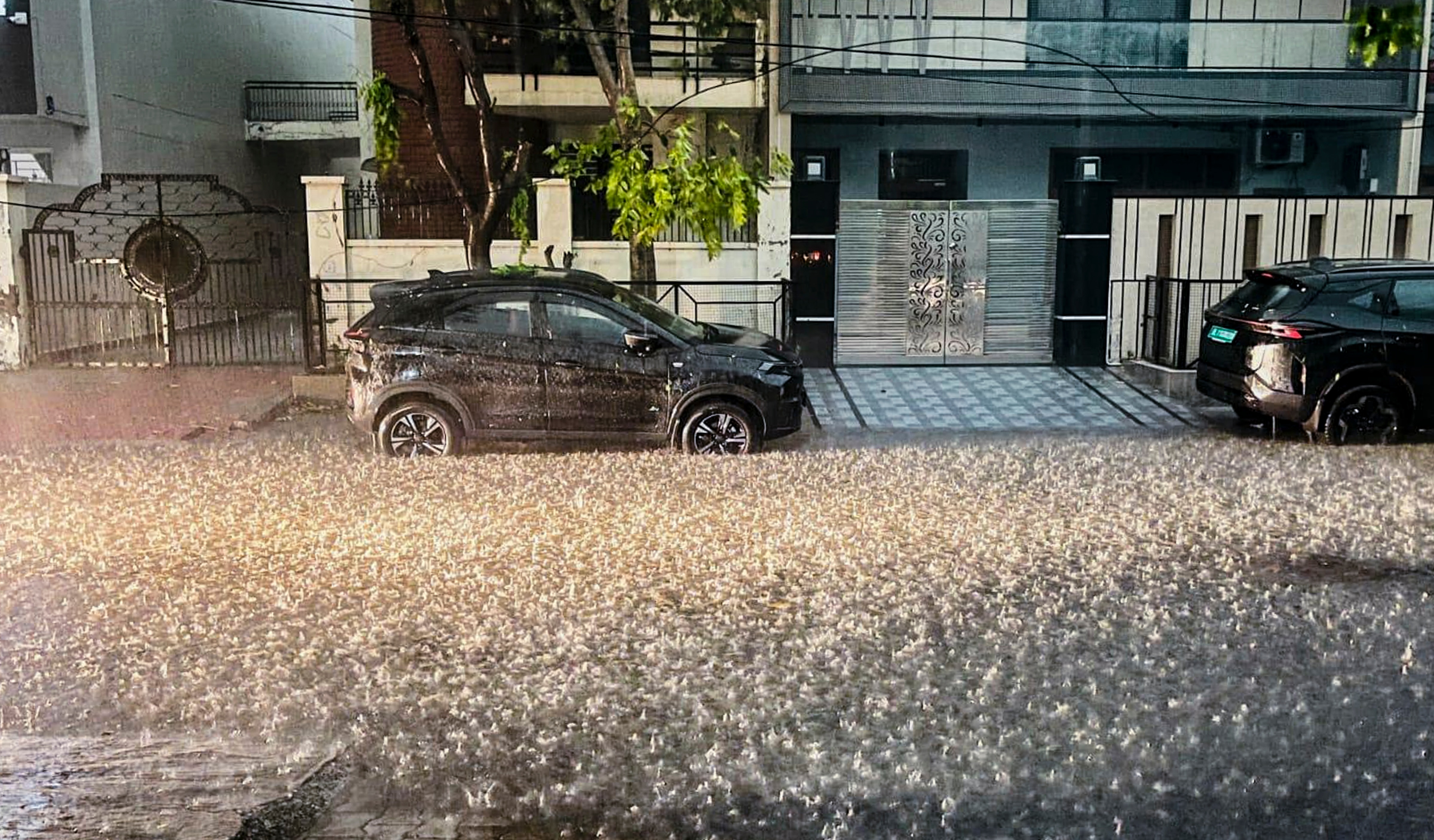 Hailstones fall during heavy rain in a residential area in Rewari, Haryana. (Photo: PTI)