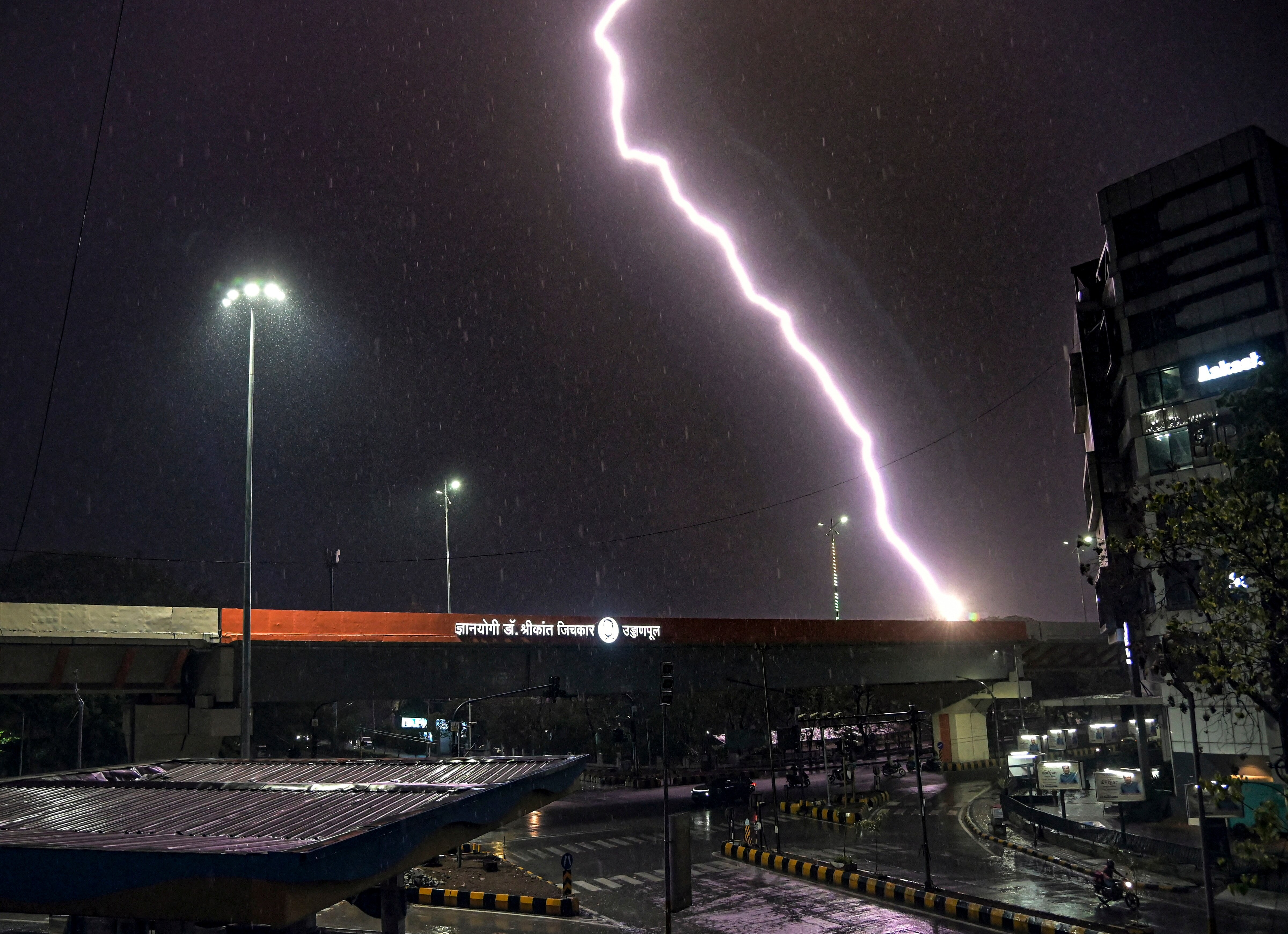 Lightning streaks across the sky as rain falls, in Nagpur. (Photo: PTI)