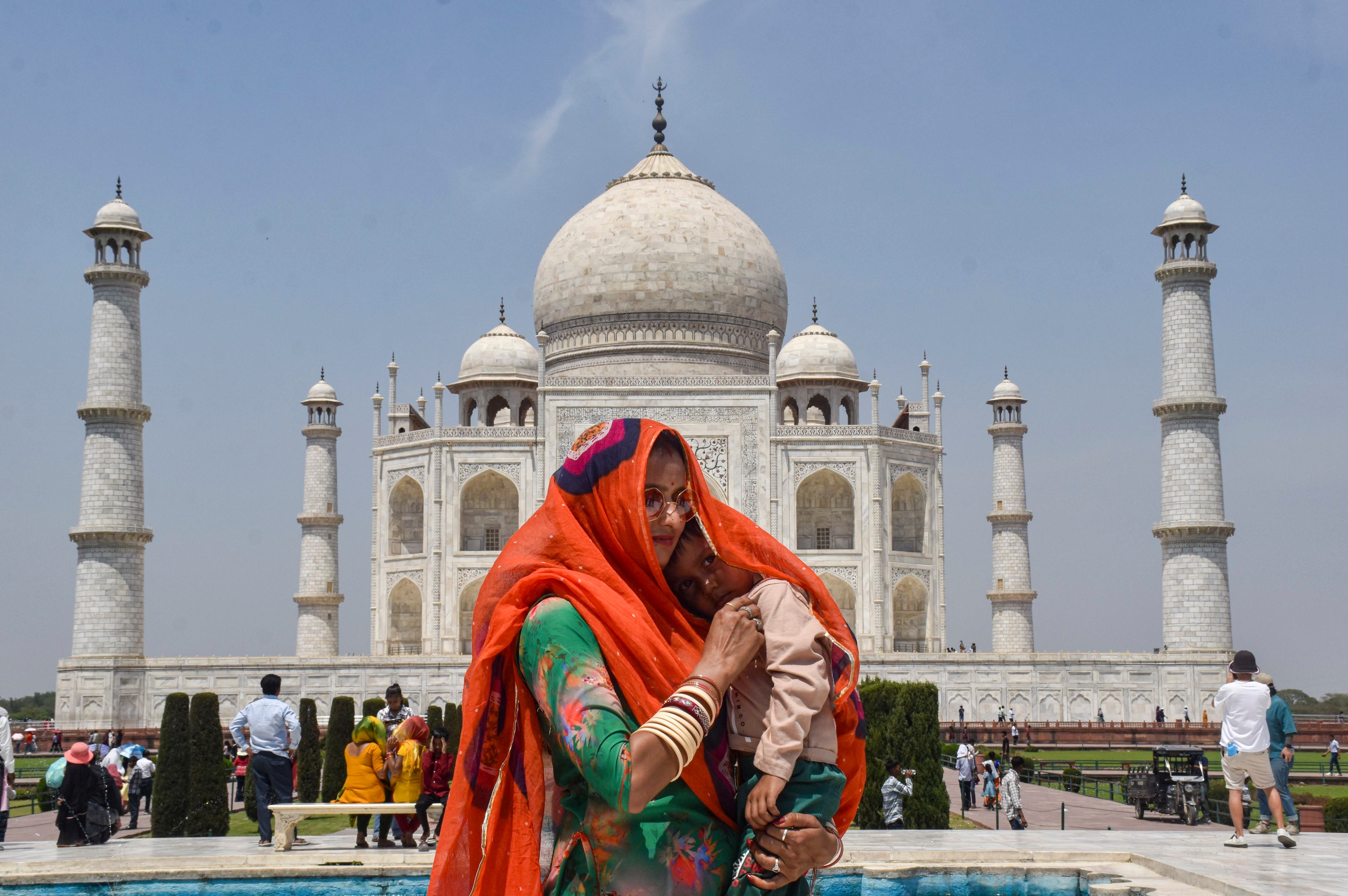 A woman covers herself and her child on a hot summer day in Agra, Uttar Pradesh. (Photo: PTI)