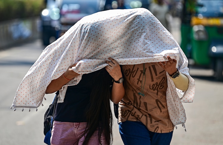 Women cover themselves on a hot summer day, in Prayagraj, Uttar Pradesh. (Photo: PTI)