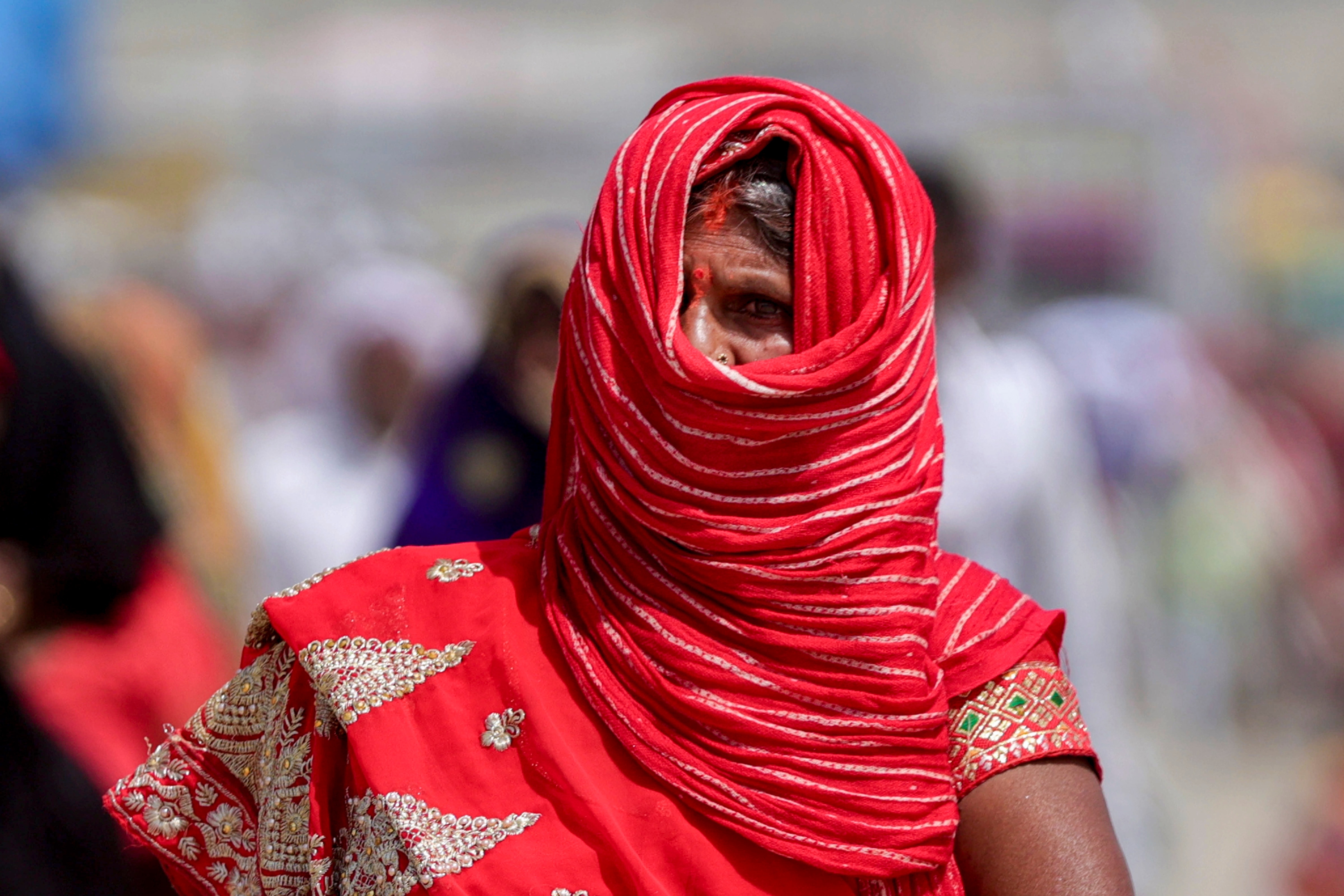 A woman covers her face to protect herself from the scorching sun on a hot day in Uttar Pradesh. (Photo: PTI)