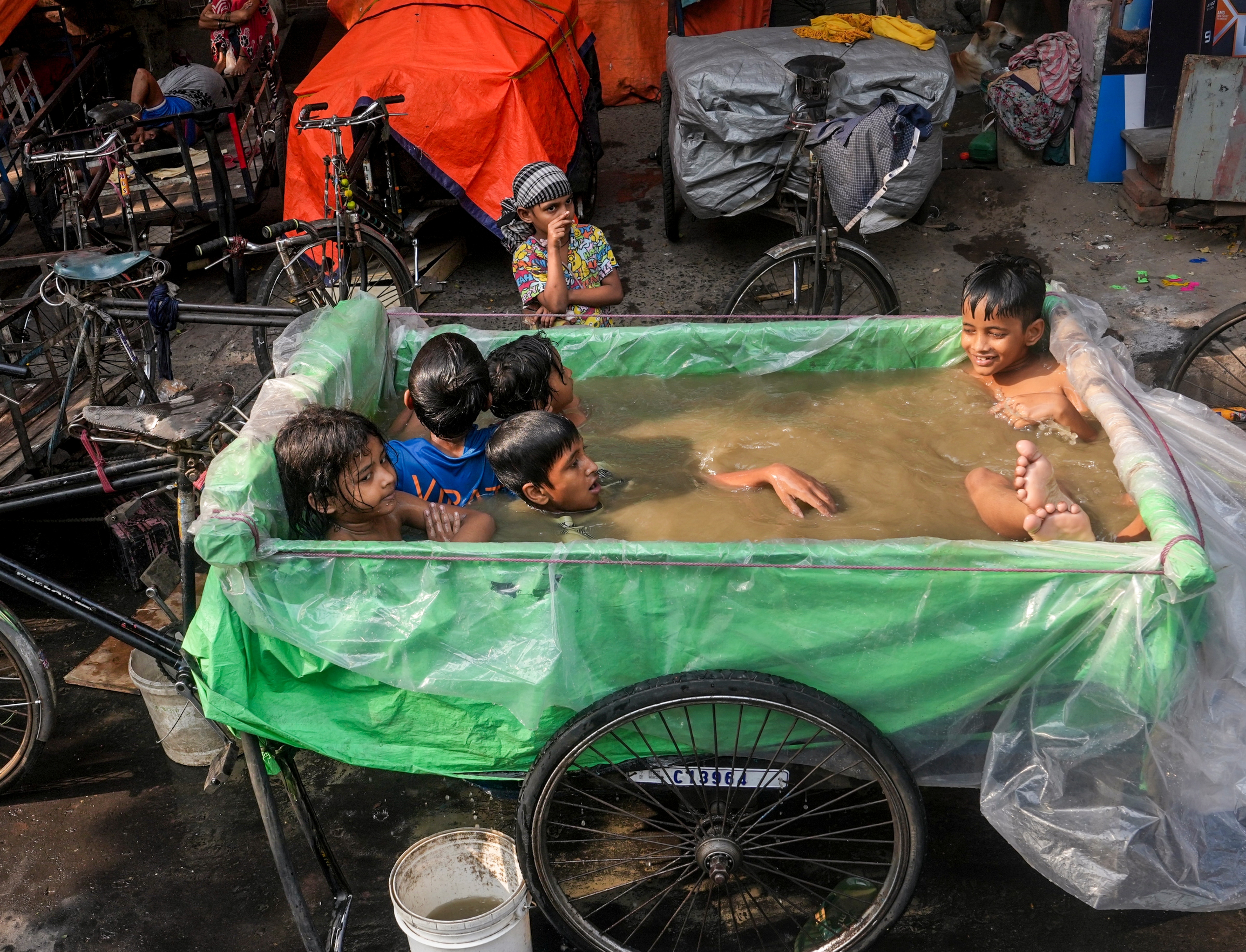 Children cool off in an improvised pool in Kolkata, West Bengal. (Photo: PTI)