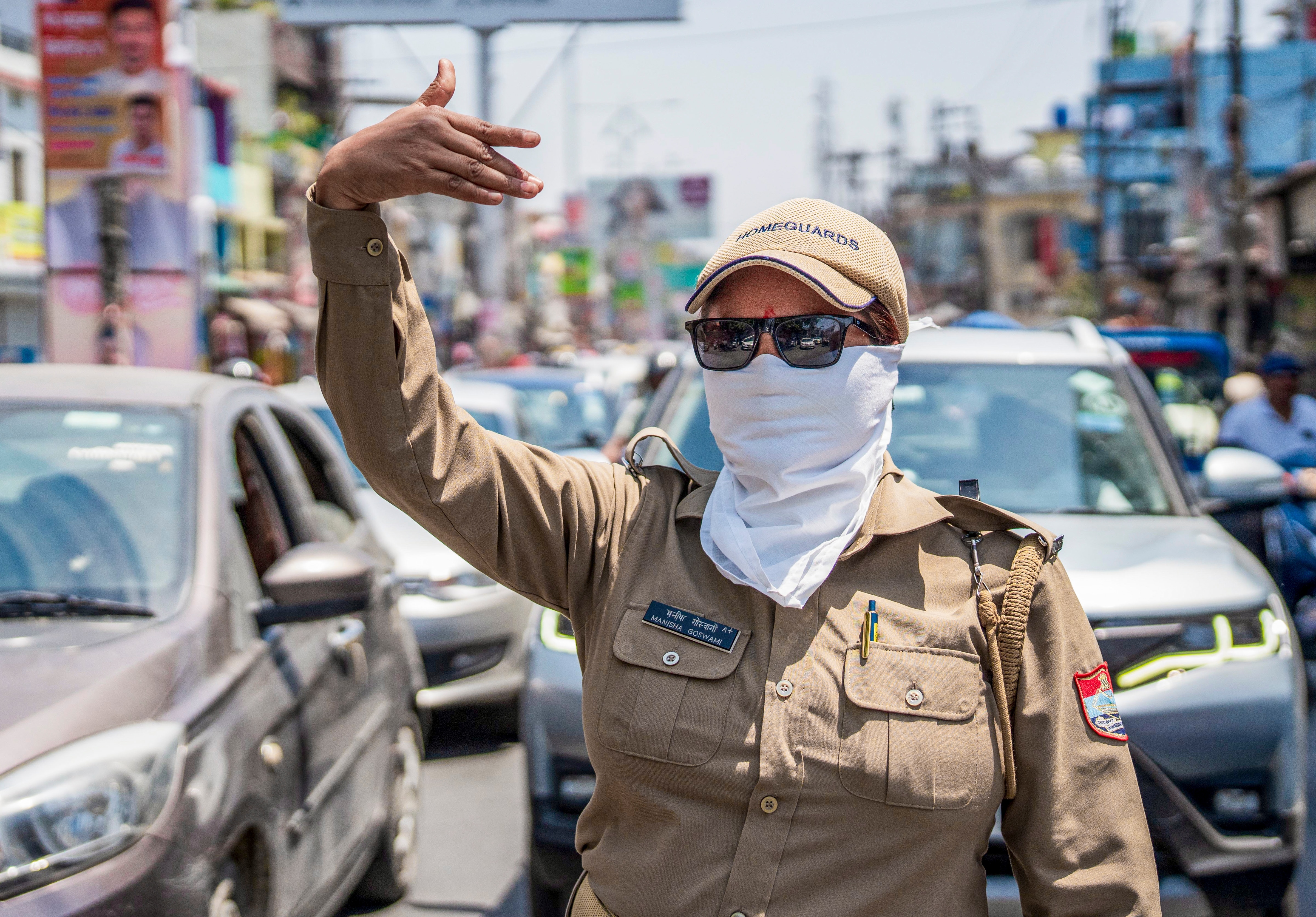 A police personnel manages traffic on a hot summer day, in Nainital, Uttarakhand. (Photo: PTI)