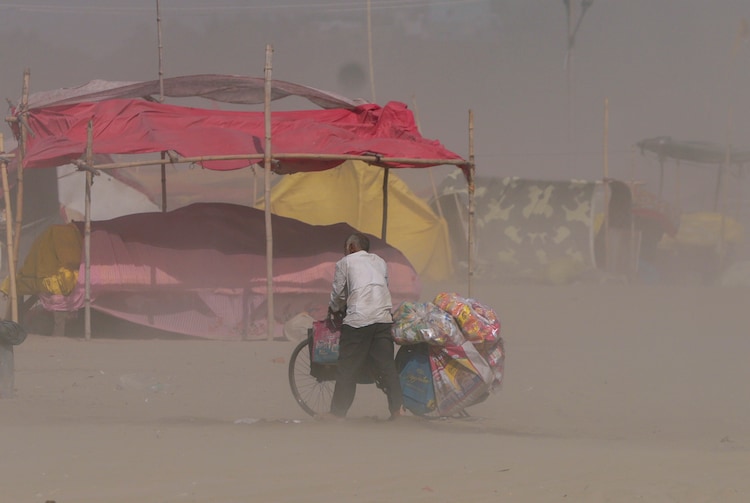 A cyclist moves through dust on a hot summer day, in Uttar Pradesh. (Photo: PTI)