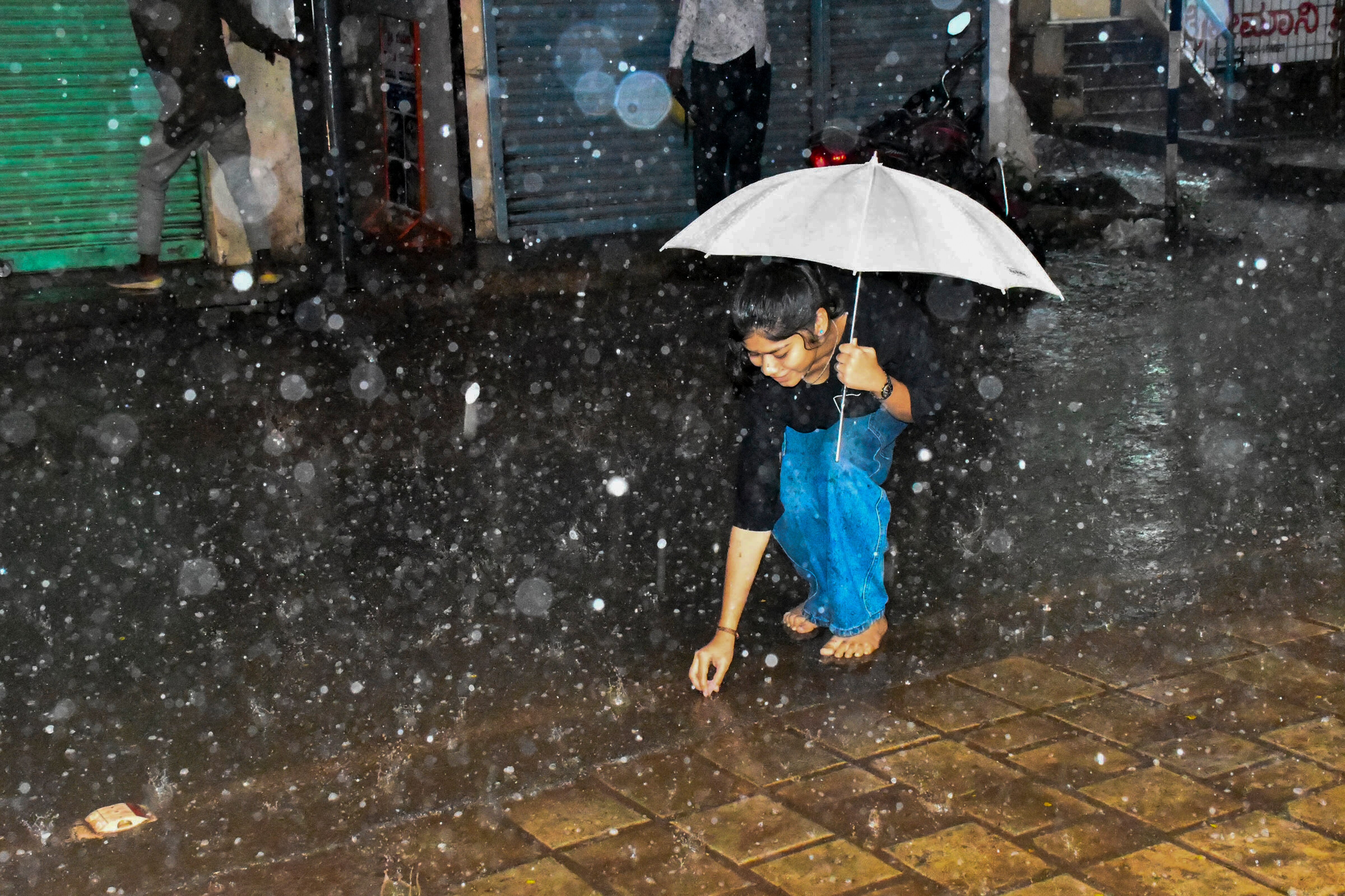 A girl collects hailstones during a hailstorm. (Photo: PTI)