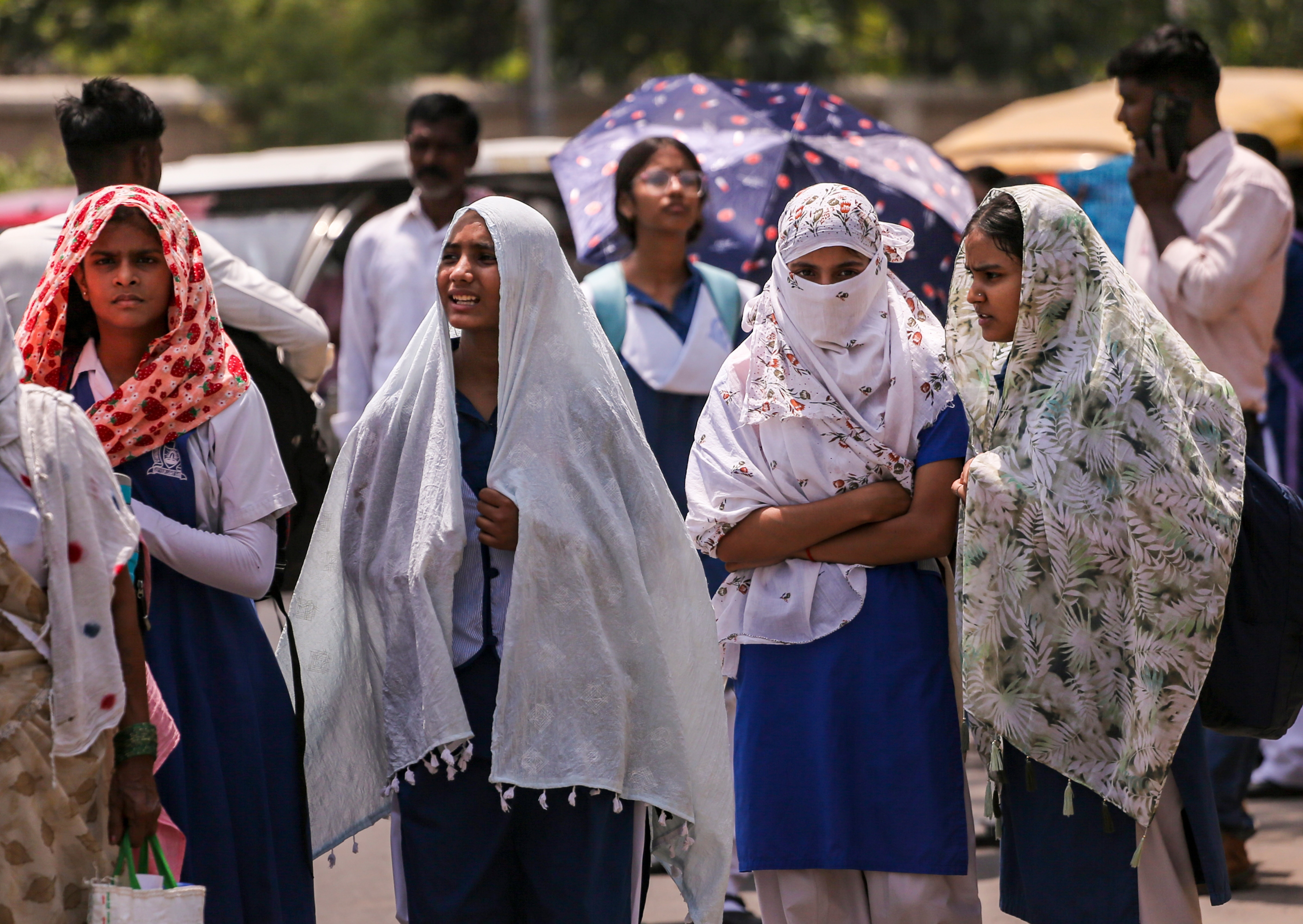 People shield themselves from heat on a hot day in Prayagraj. (Photo: PTI)