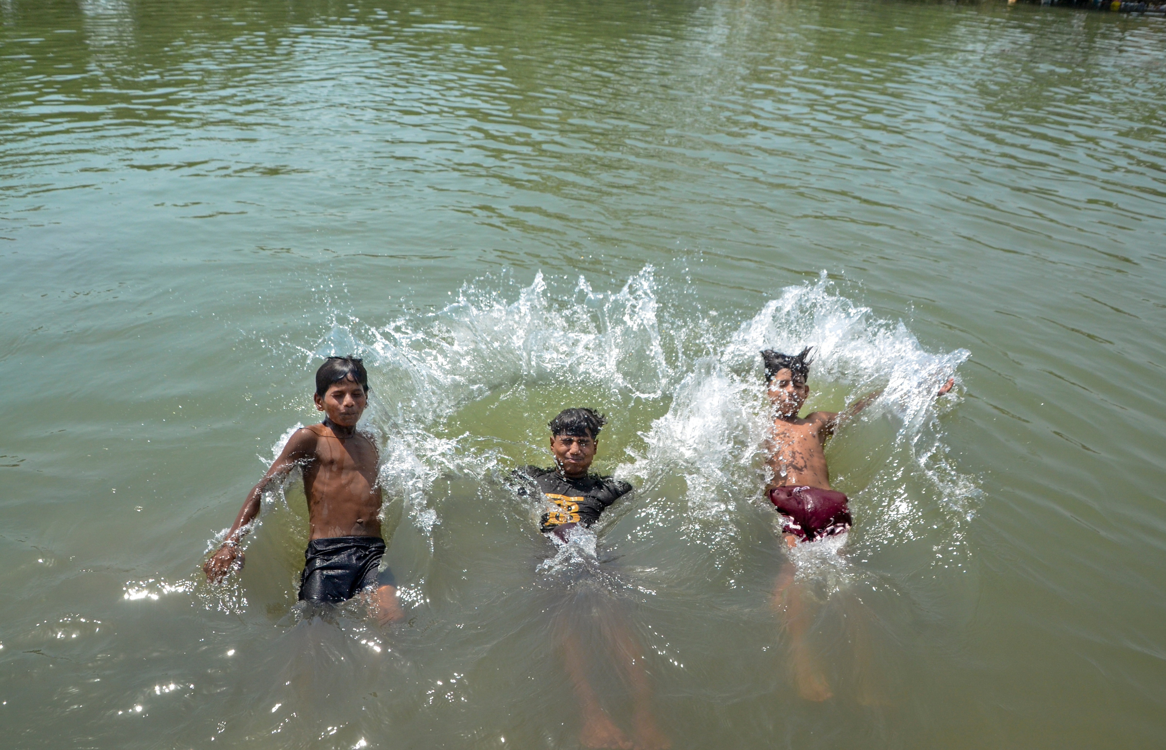 Children take bath in a canal on a hot summer day, in Kanpur, Uttar Pradesh. (Photo: PTI)