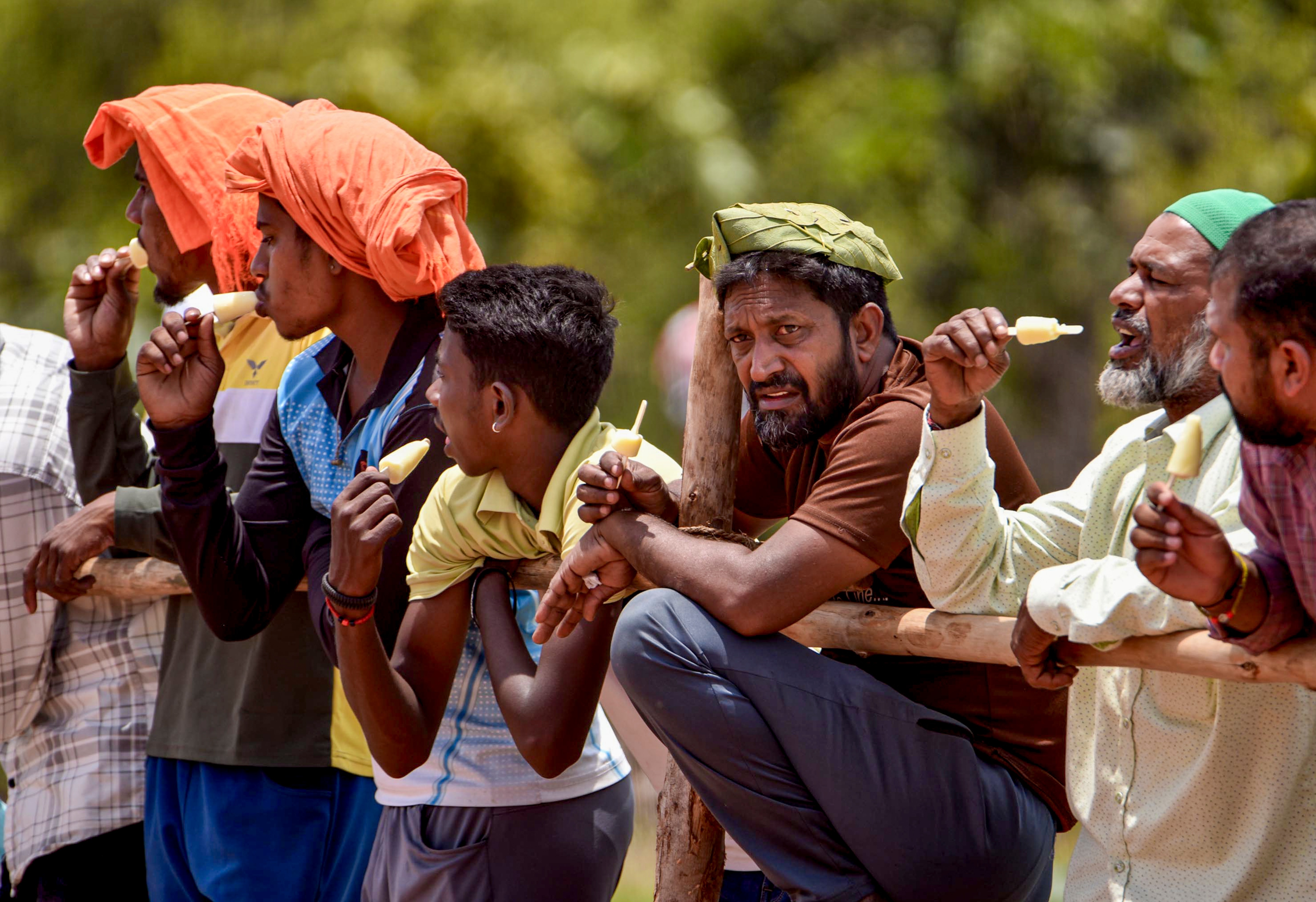People eat an ice candy on a hot day in Karnataka. (Photo: PTI)