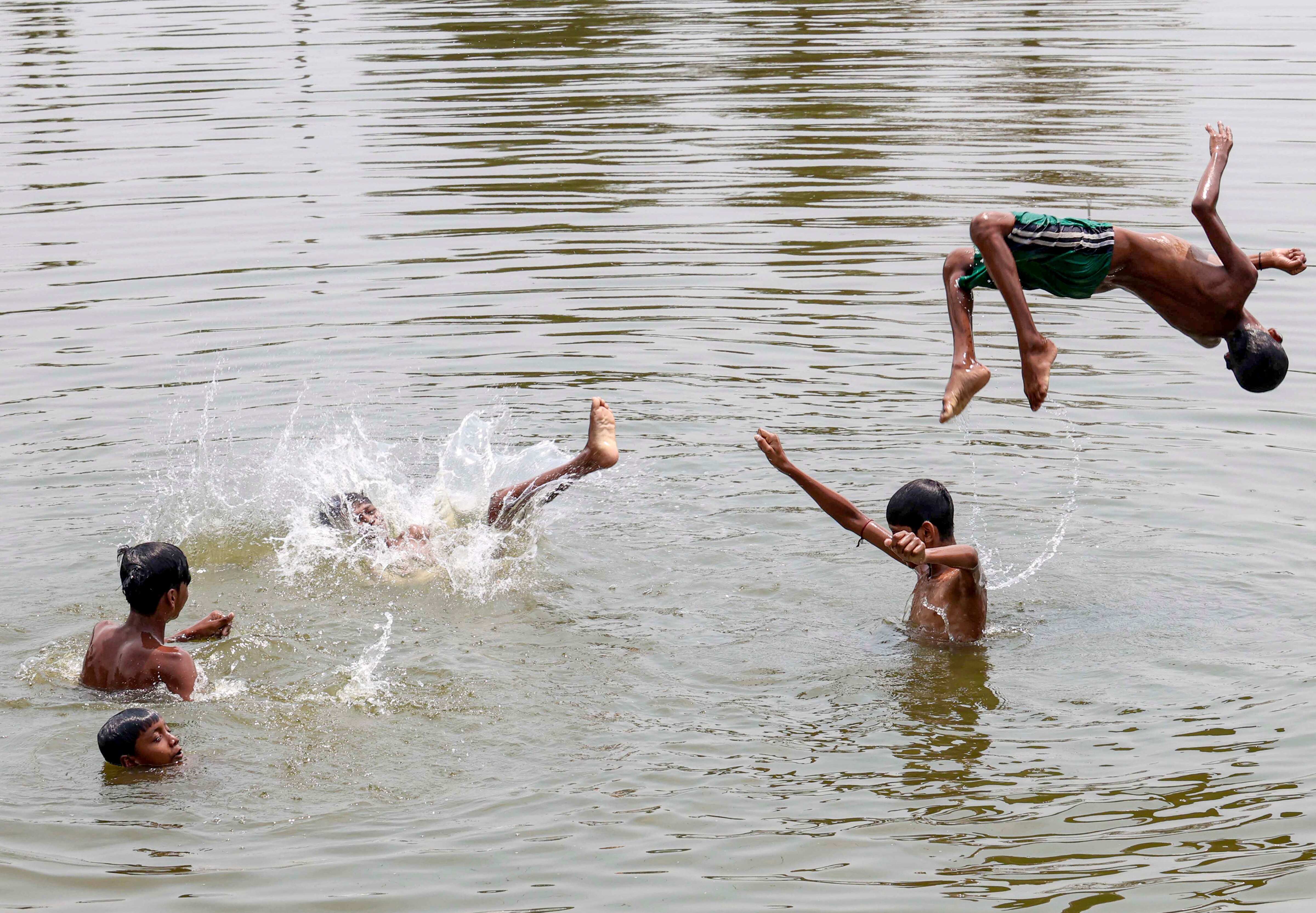 Boys play in a pond to beat the heat in West Bengal. (Photo: PTI)