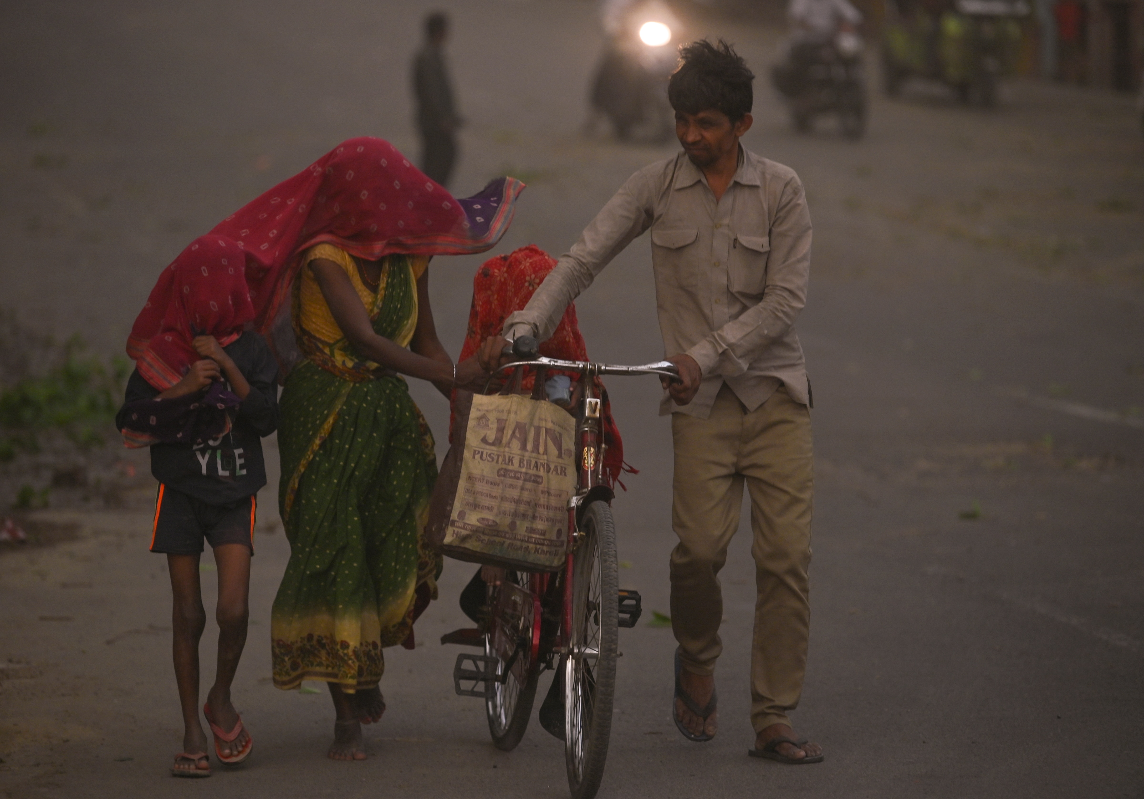 Children and adults walk through a dust storm in Uttar Pradesh. (Photo: PTI)