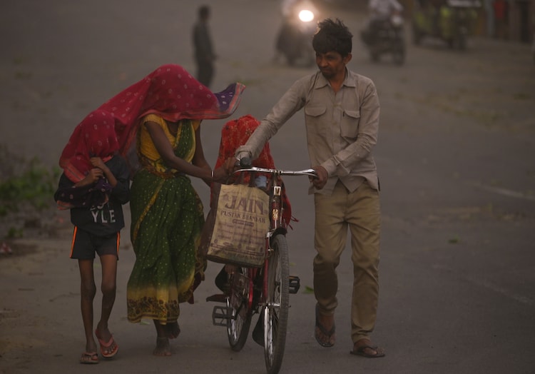 Children and adults walk through a dust storm in Uttar Pradesh. (Photo: PTI)