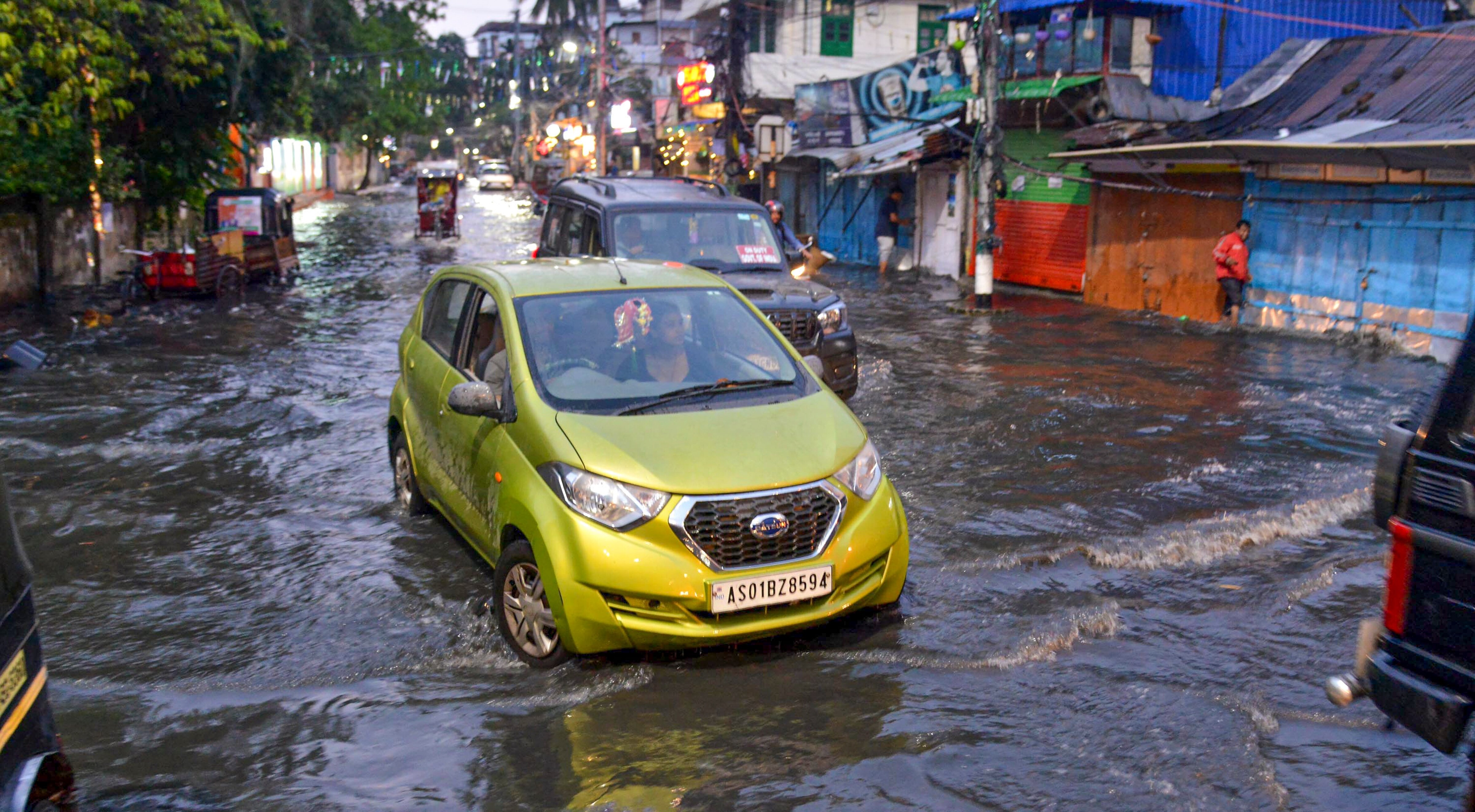 Vehicles wade through a waterlogged road following heavy rainfall, in Guwahati, Assam. (Photo: PTI)