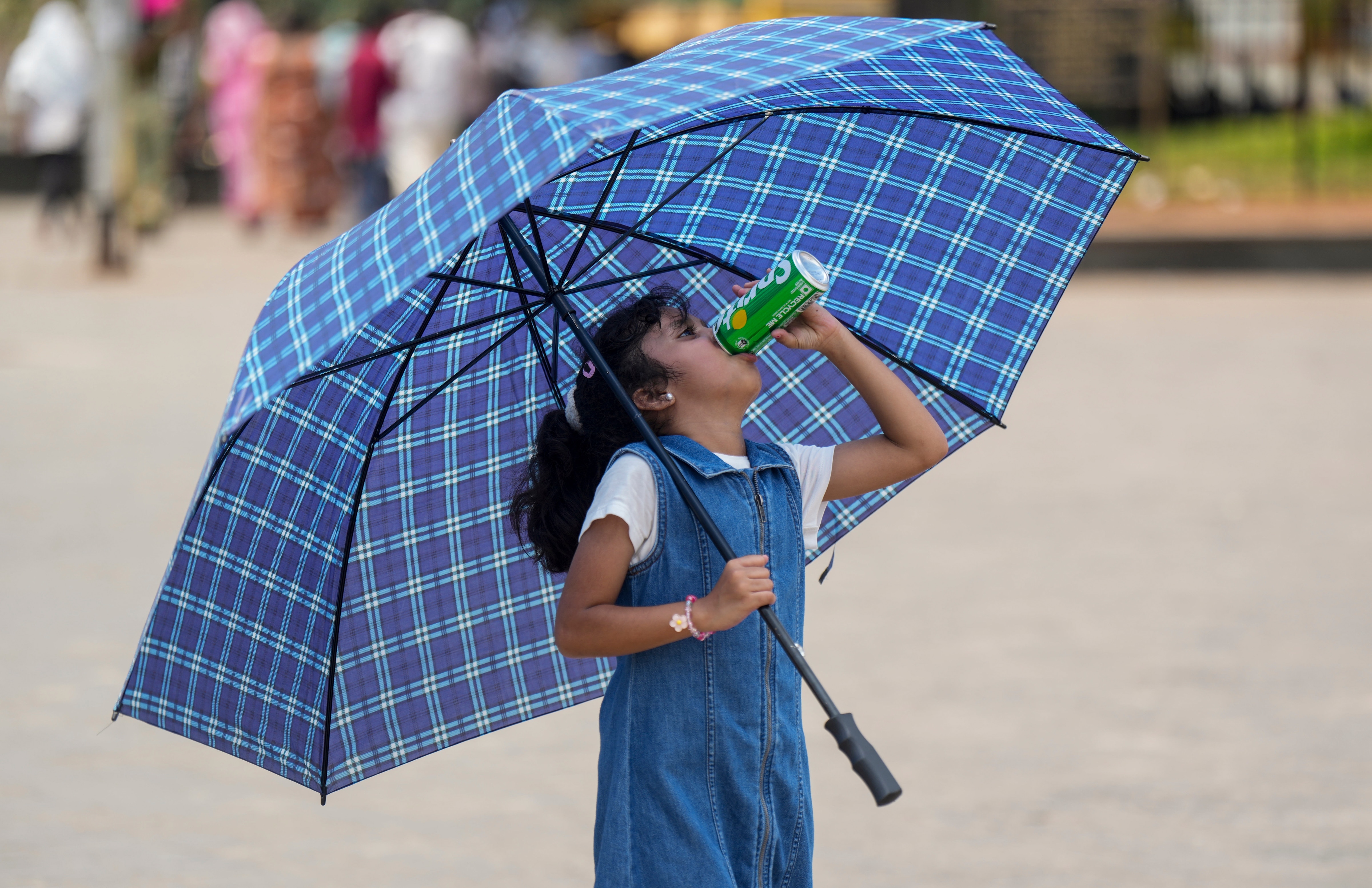 A young girl drinks a cold drink on a hot day. (Photo: PTI)