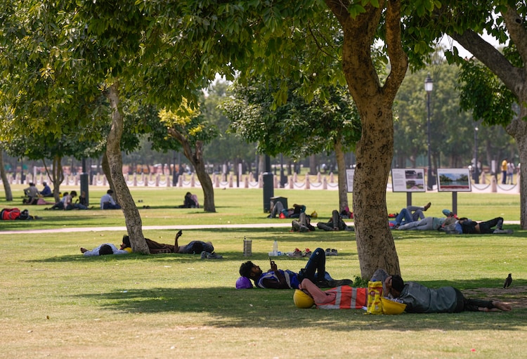 Workers and others rest at the India Gate lawns on a hot summer day, in New Delhi. (Photo: PTI)