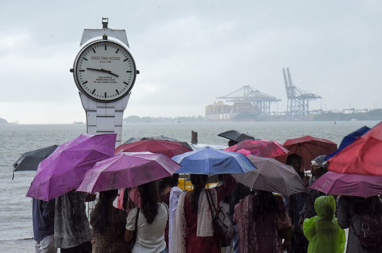 People at Marine Drive in Kochi, Kerala prepared for rain. (Photo: PTI)