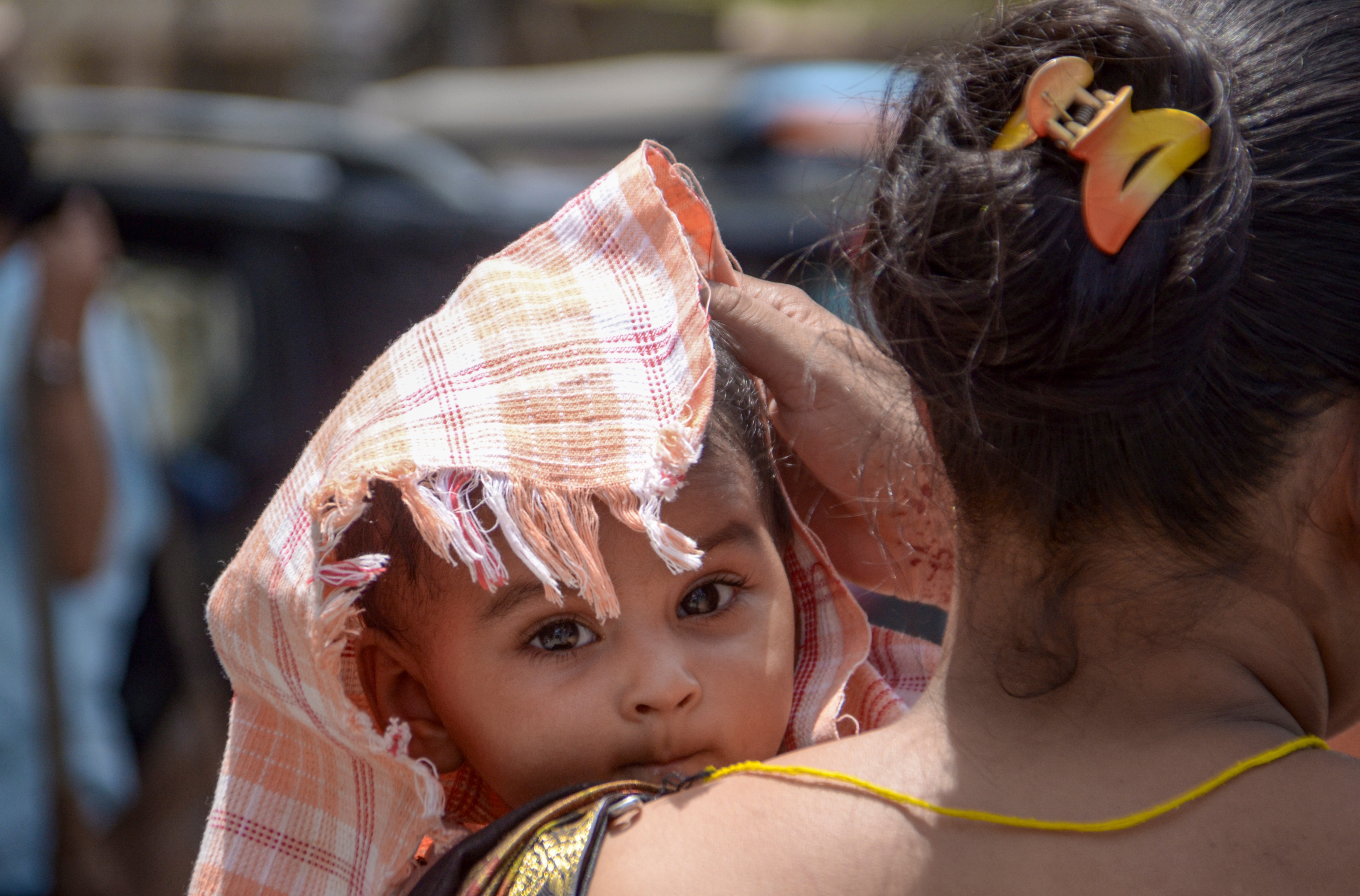A woman covers a child on a hot summer day, in Kanpur, Uttar Pradesh. (Photo: PTI)